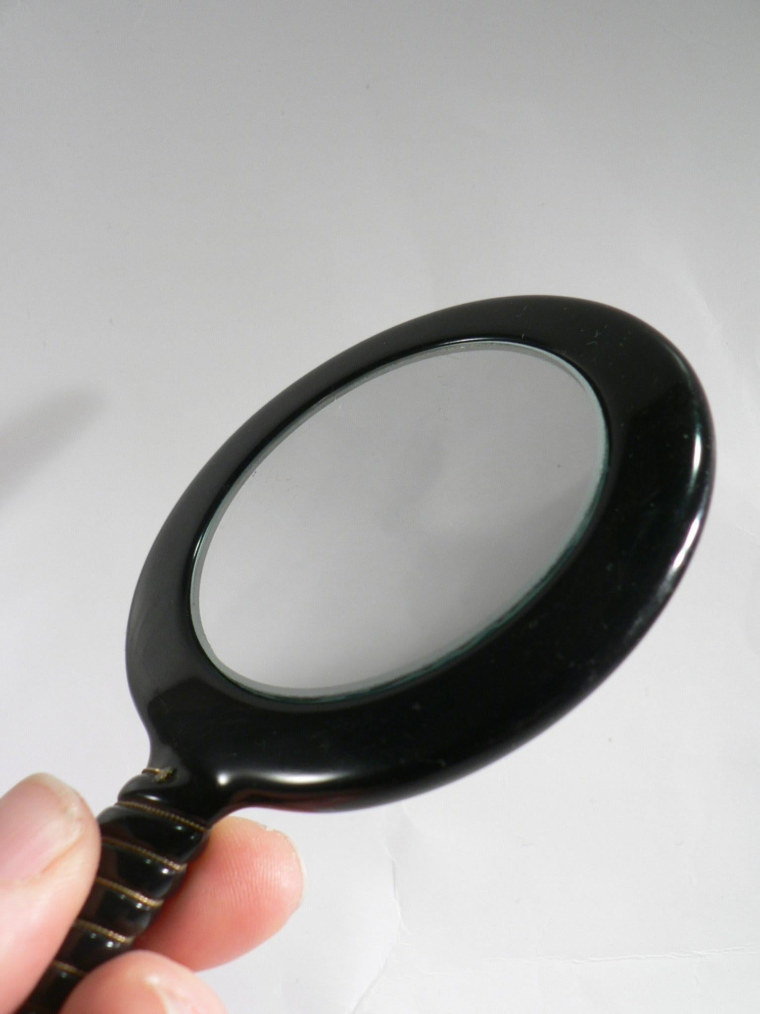 French A black Bakelite handheld mirror double-sided - France - 1950. For Sale