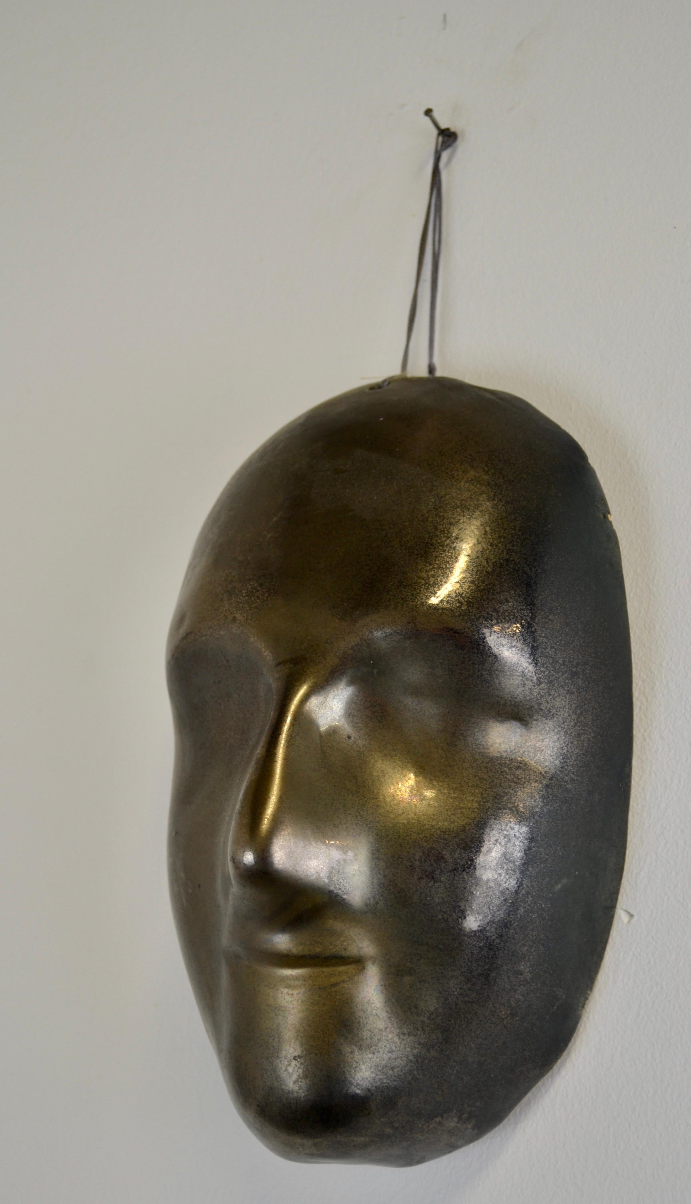 French A black enamelled ceramic mask with bronze-gold highlights France 1950s For Sale