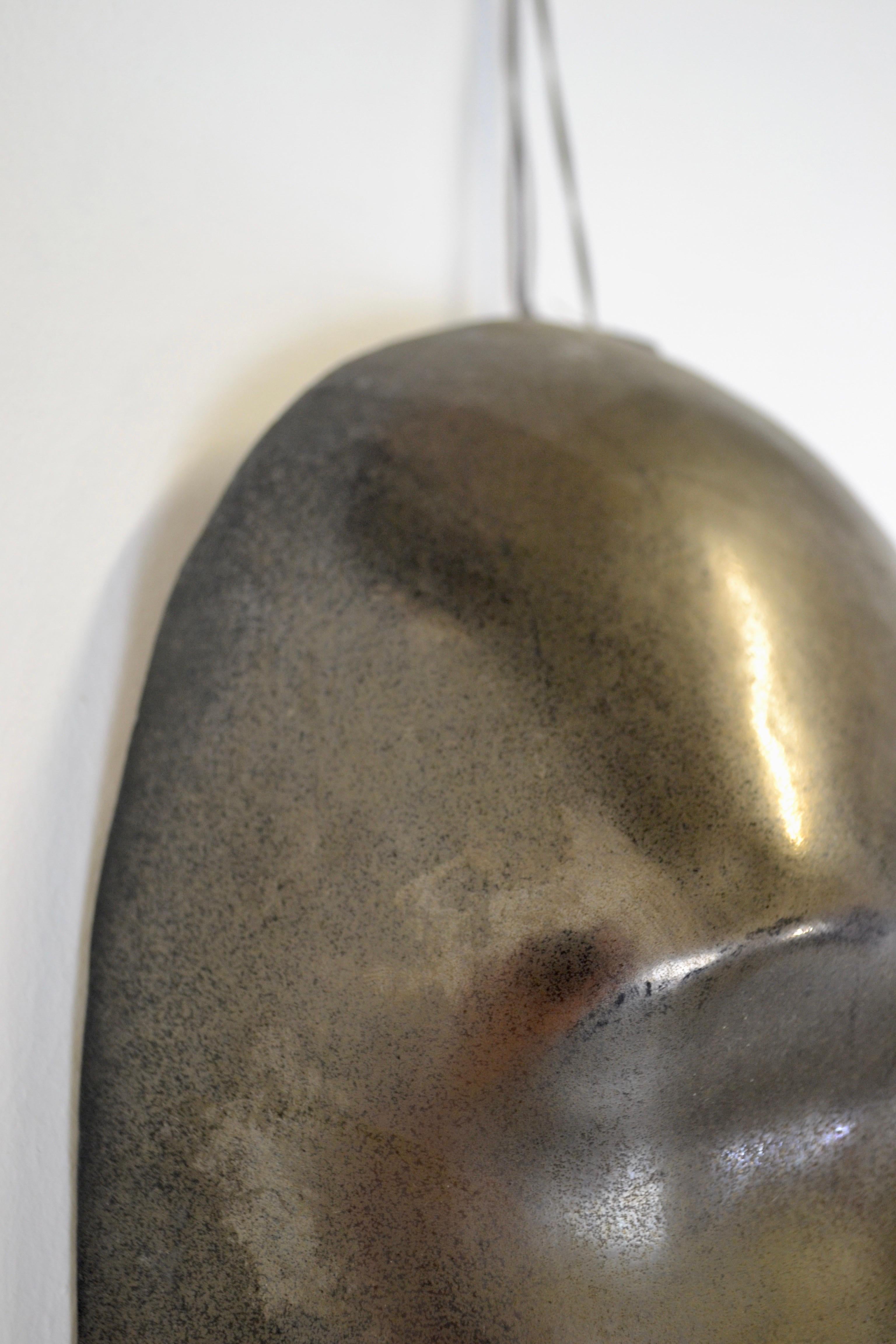 Ceramic A black enamelled ceramic mask with bronze-gold highlights France 1950s For Sale