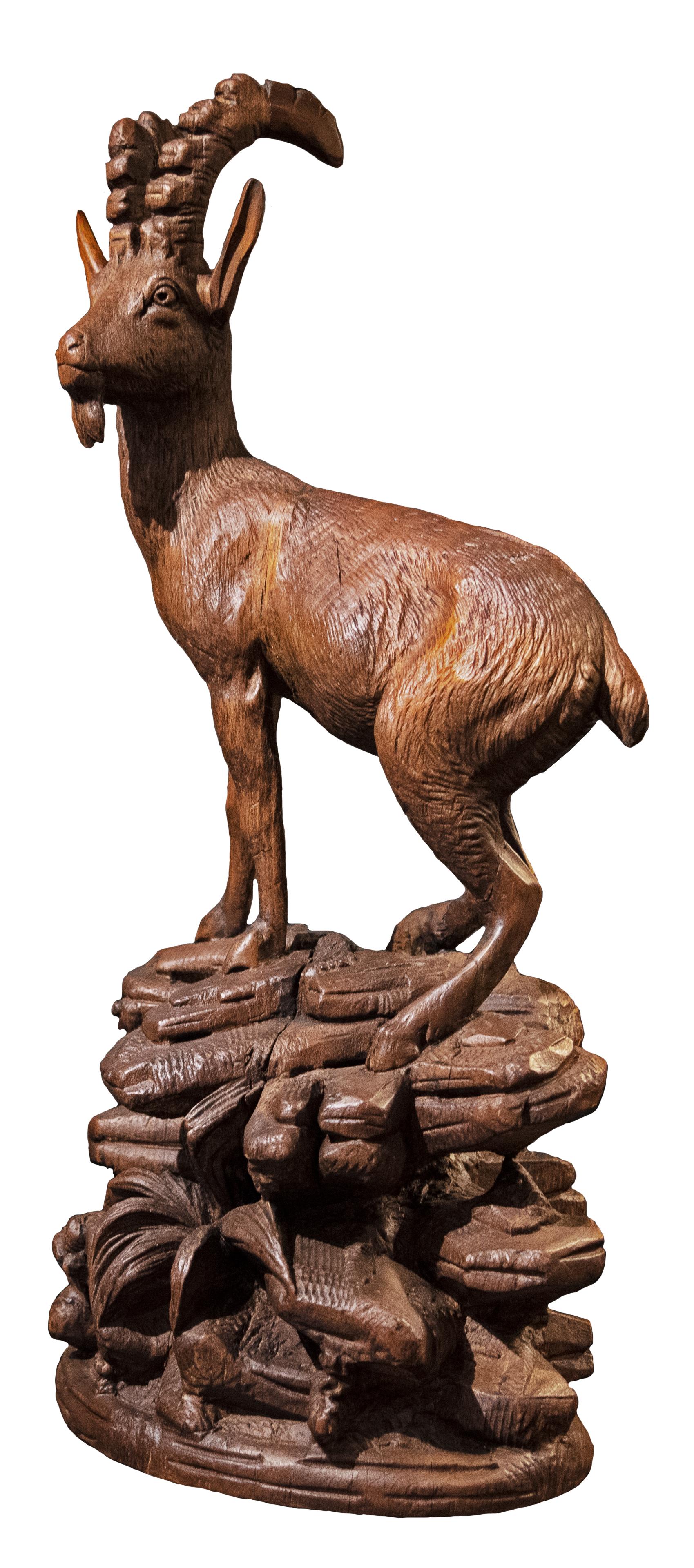 A nineteenth-century Swiss wood sculpture of a bearded ibex atop a rocky landscape.

Carved in the Black Forest style, popular in the late nineteenth century.
