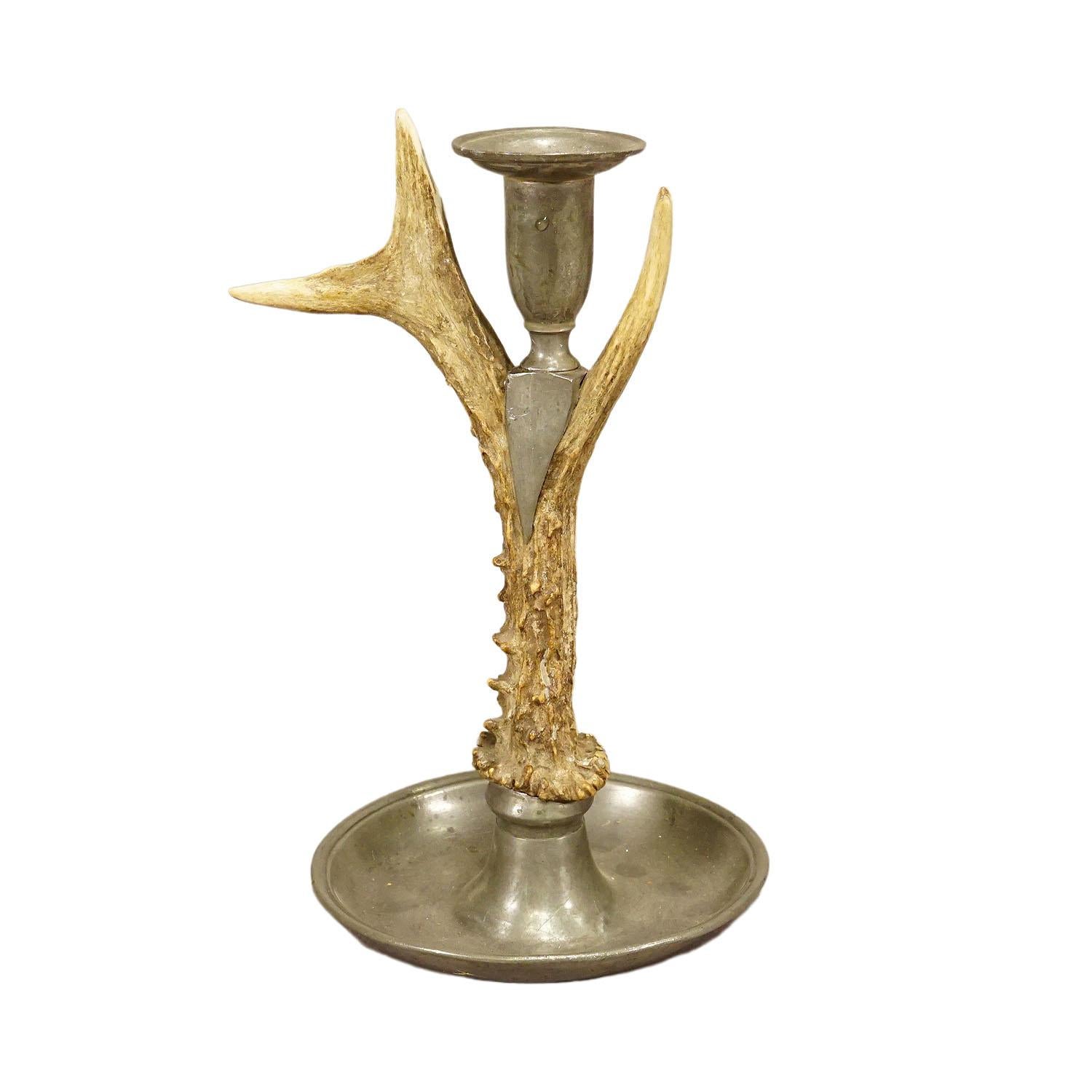 A Black Forest Candle Holder with Pewter Base and Spout, Germany circa 1860s

An antique Black Forest candle holder with pewter base and spout. Made with an original deer antler. Manufactured in South Germany mid 19th century. Excellent