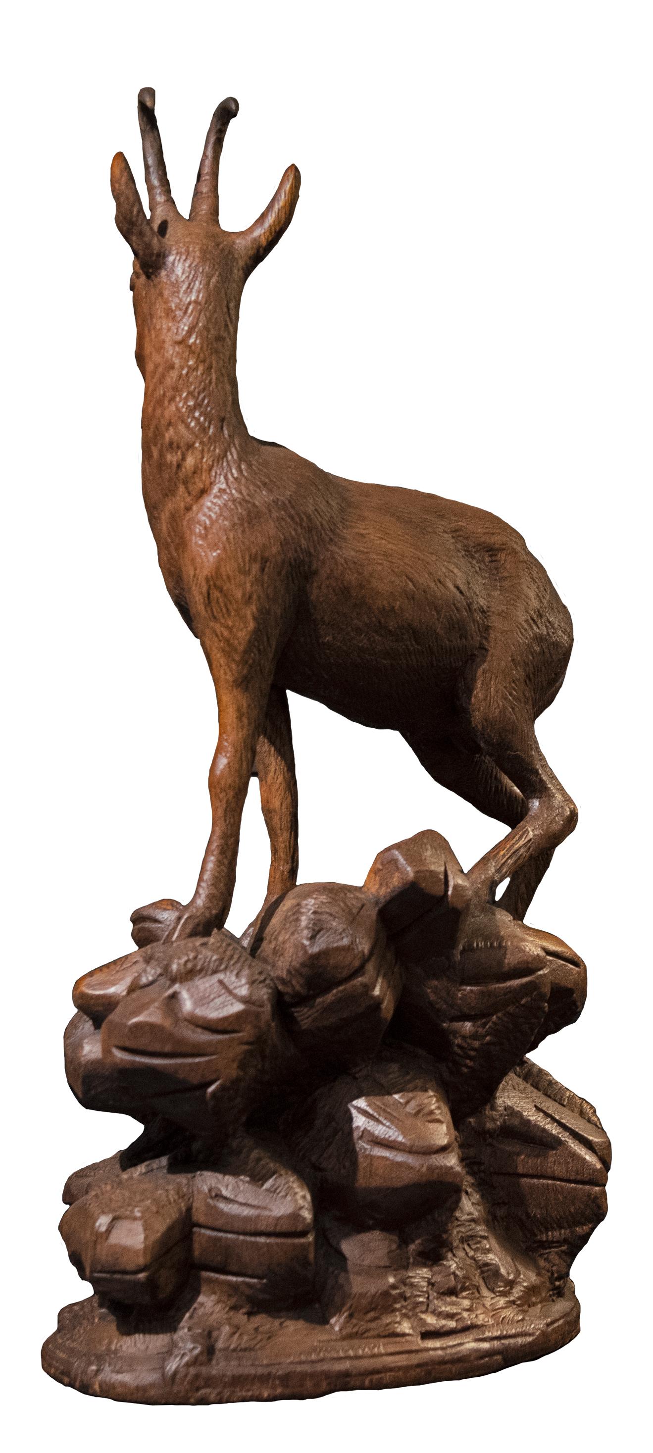 A nineteenth-century Swiss wood sculpture of a single ibex atop a rocky landscape.

Carved in the Black Forest style, popular in the late nineteenth century.