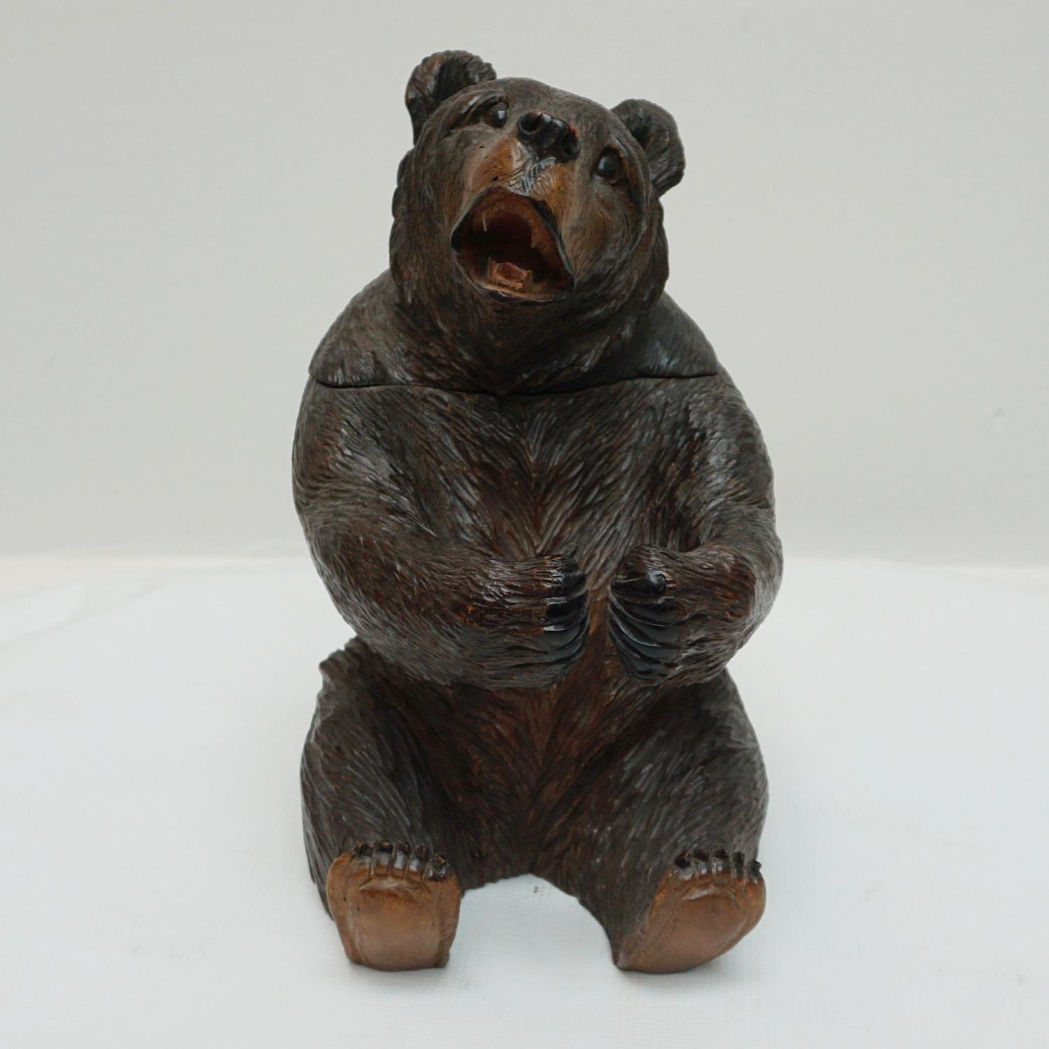 A Black Forest seated carved bear as a tobacco jar. Finely carved detail. Original glass eyes. Linden Wood.

Dimensions: H 25cm W 15cm D 20cm

Origin: Swiss

Date: circa 1900

Item Number: 1605232.