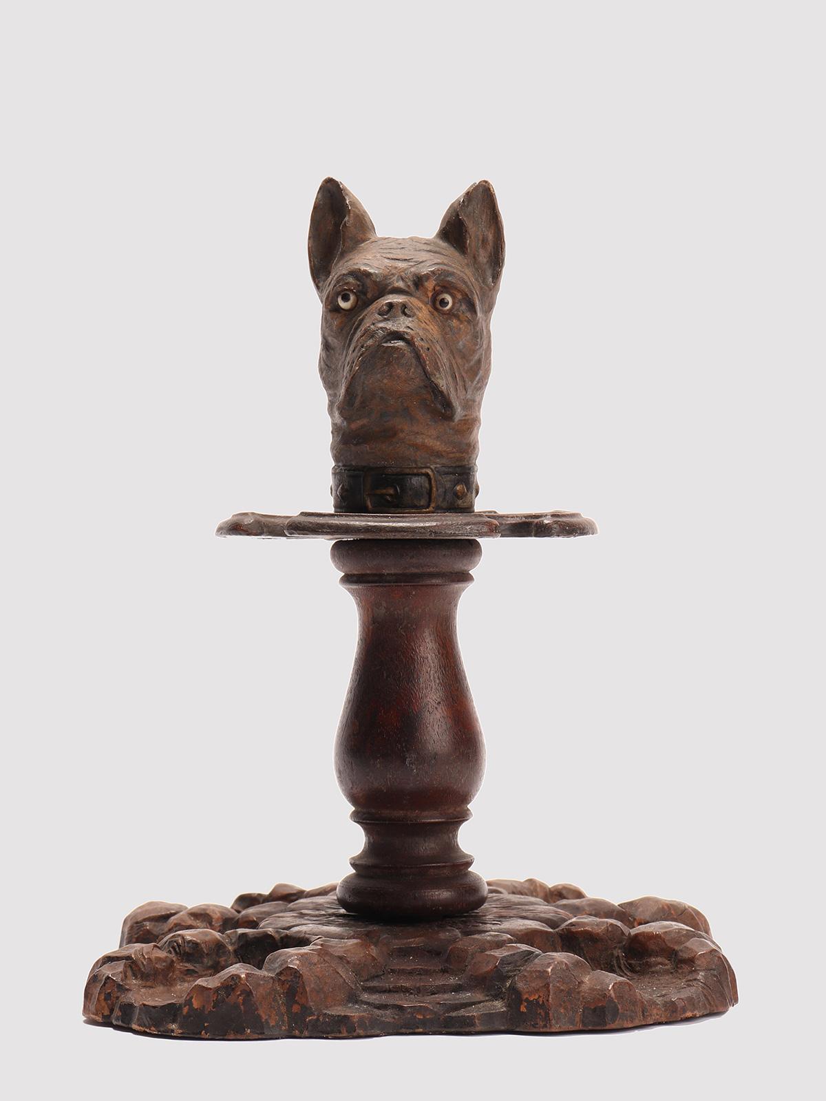 Pipe holder, made of carved wood depicting a french bulldog. Glass paste eyes. Black Forest, Germany, circa 1900.