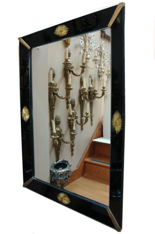 A Venetian circa 1930s mirror made of black glass frame with etched gilt rosettes on each side of the mirror.

Measurements: 
Height 40.5