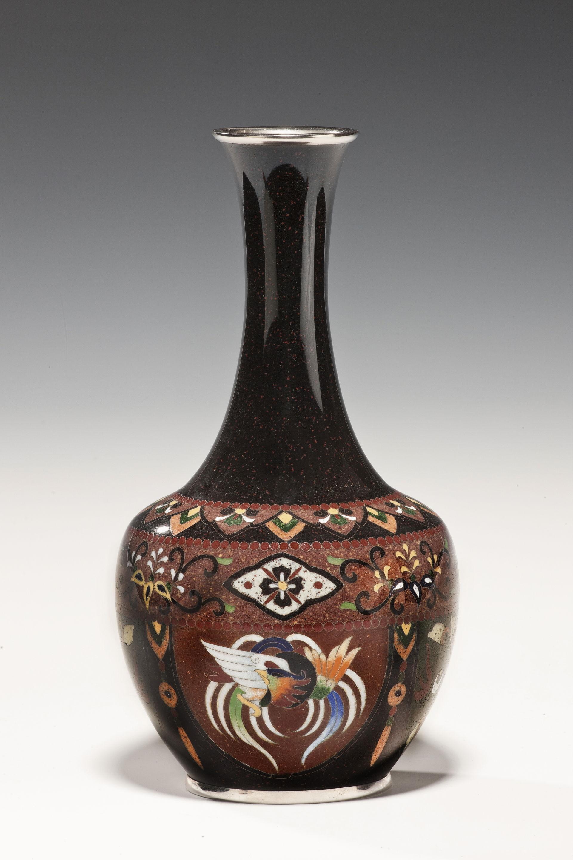 This bottle vase has lappets of ho-o birds on a ‘gold-stone’ ground, chrome mounts, 20th century.