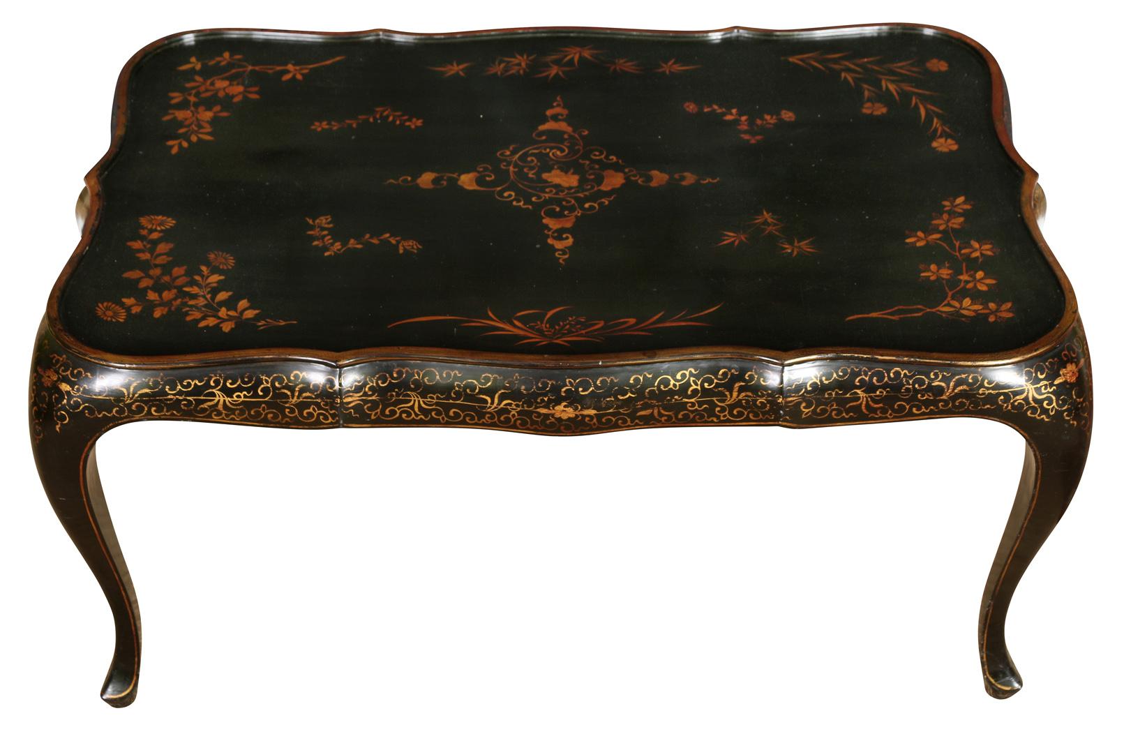 A charming little black lacquered cocktail table with a scalloped top and cabriole legs, hand painted in a gold floral motif.  