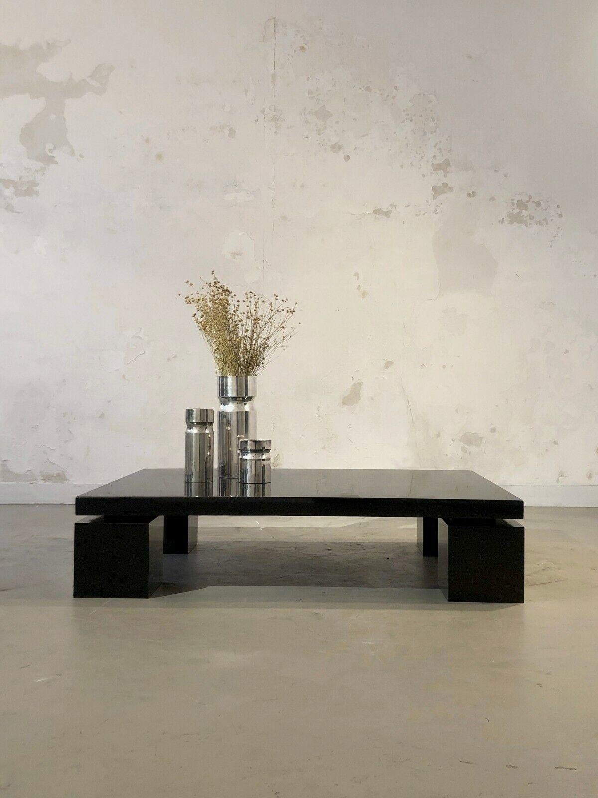 A large and rigorous rectangular coffee table, Post-Modern, Memphis, Constructivist, geometric structure of the laminate wood lacquered in black, heavy square legs, the tray in semi-suspension, by Willy Rizzo, ed. Cidue, Italy 1970-1980.