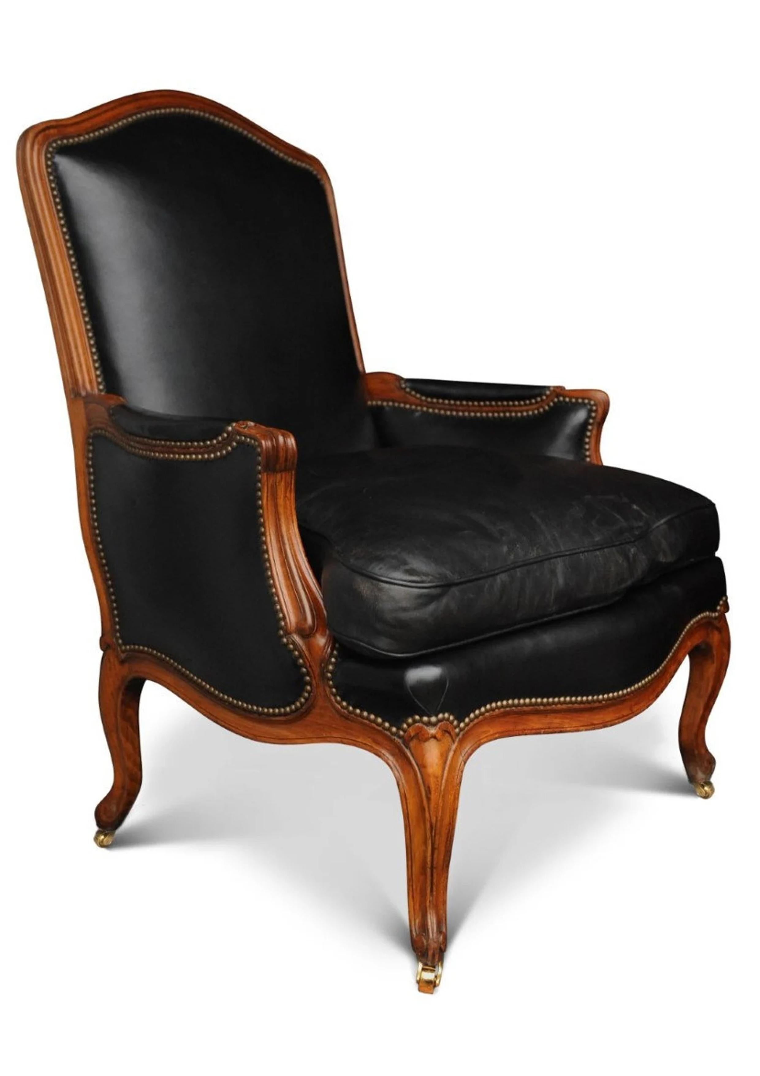 A black leather Louis XV French Bergere armchair finished with brass stud detailing

Measure: Height to seat 47cm.