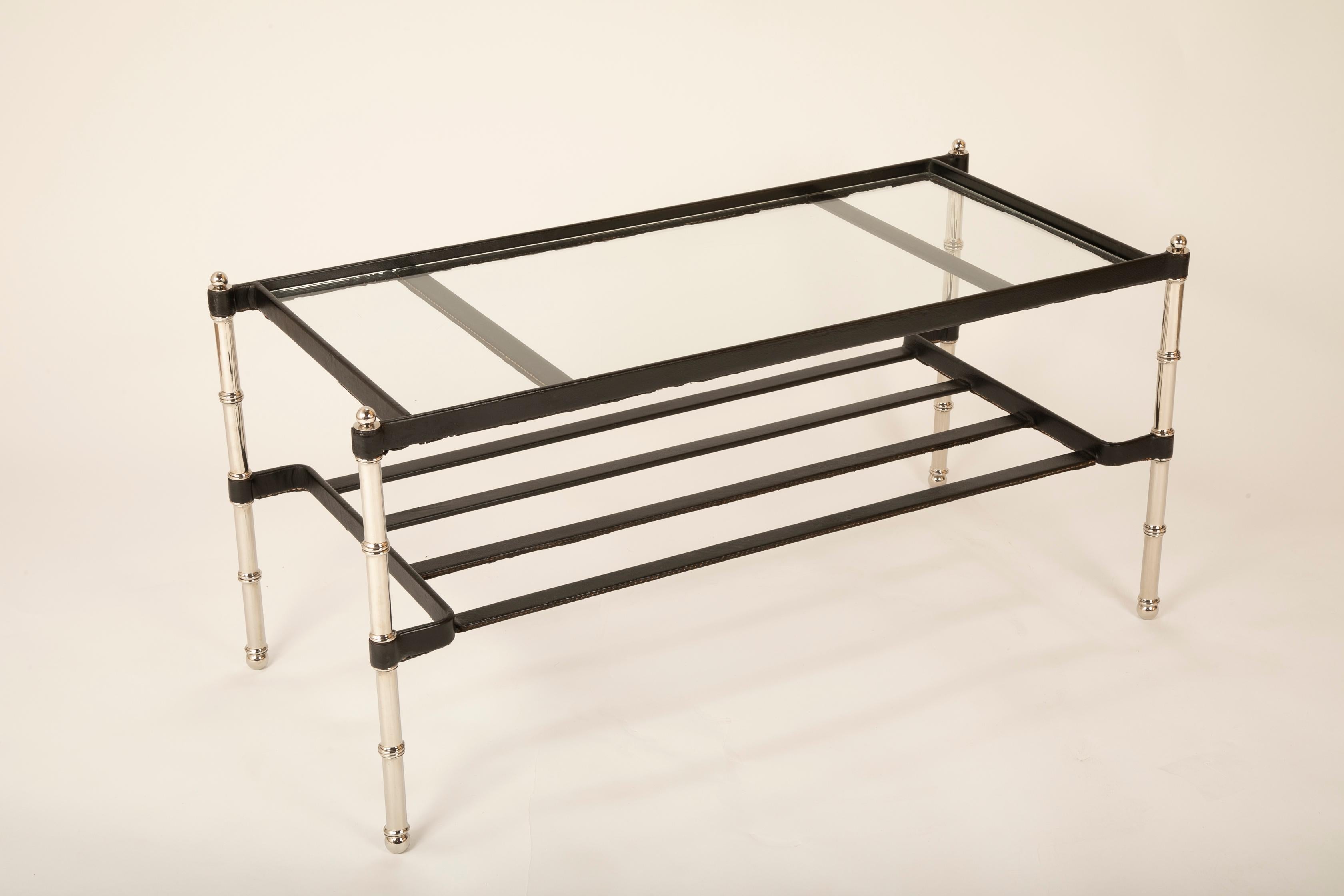 A hand stitched leather wrapped chrome coffee table designed by Jacques Adnet with glass top.