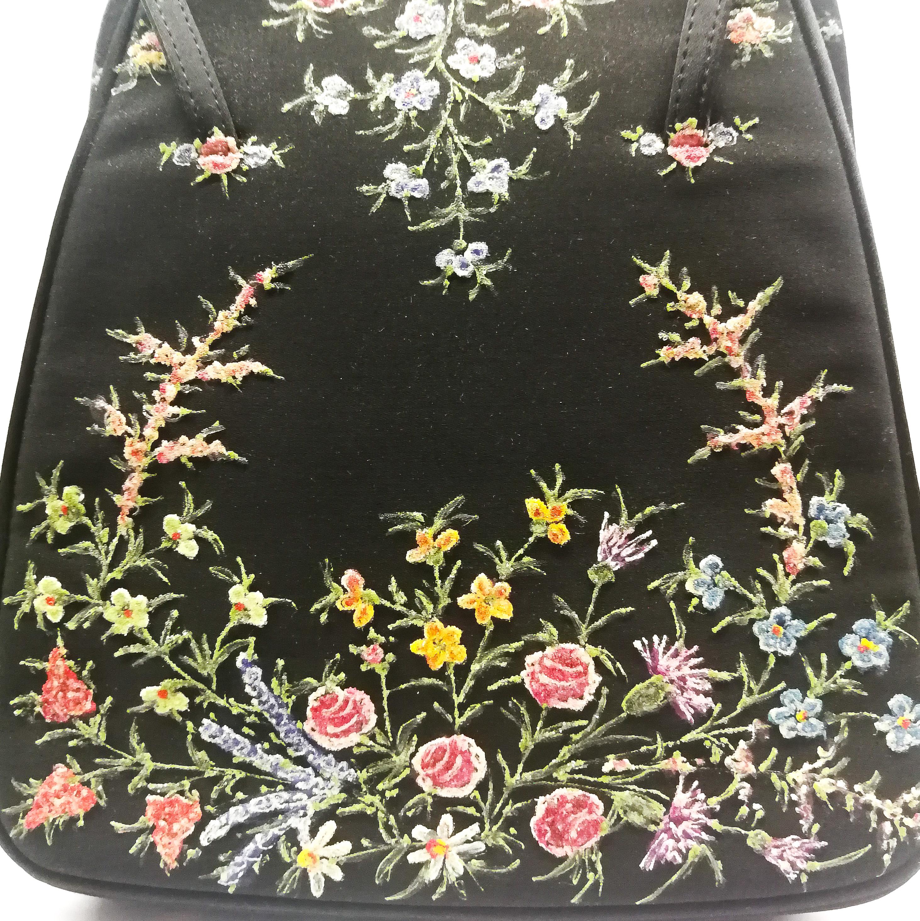 This is a very collectable Waldybag, made in their very distinctive and recognisable style. Created from black silk, with a contrasting lining in deep olive silk, it has chrome fittings/closures and a hand painted silk double handle. Minuscule glass
