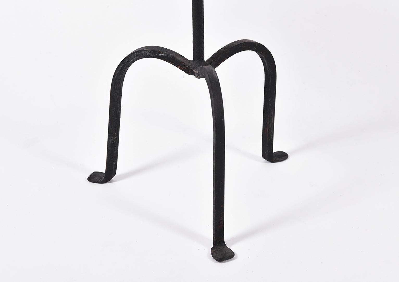 A black patinated wrought iron martini table, 
Spain, second half of the 20th century.