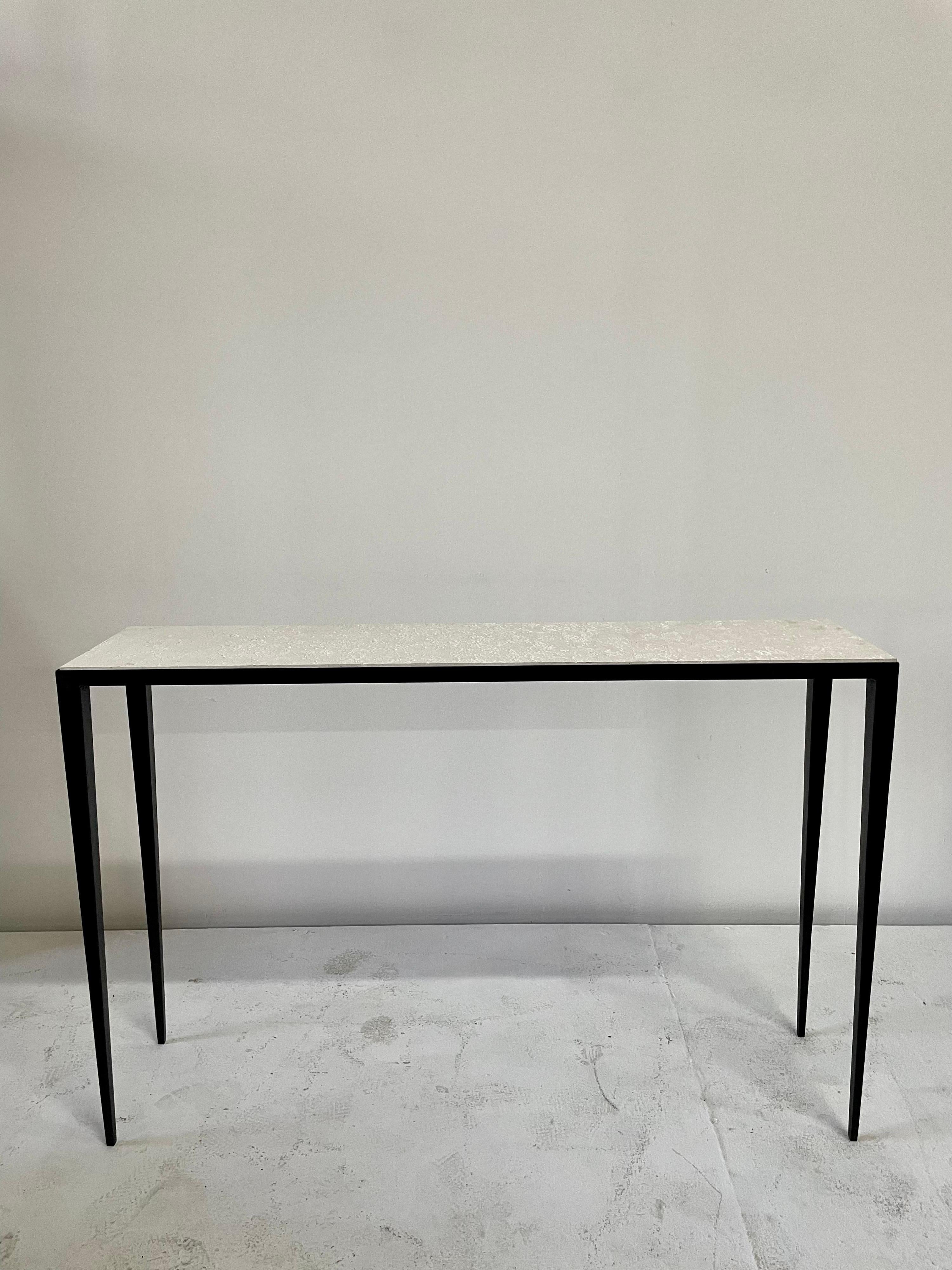 After an iconic design by JMF, this sleek console table features tapering legs with a beautifully textured limestone top which sits inside the console walls. NOTE: there is a SECOND console available if you need a PAIR - priced individually.