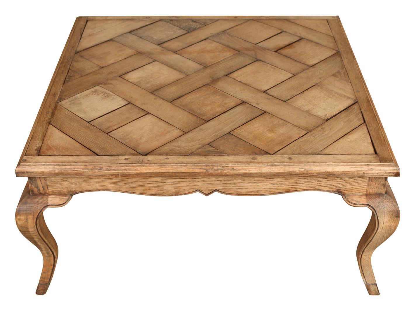 A great looking bleached oak cocktail table with a parquet pattern on the top and cabriole legs. Although the table is traditional in style, its bleached finish gives it a fresh look.  Sturdy in its composition, this table can withstand a lot of use