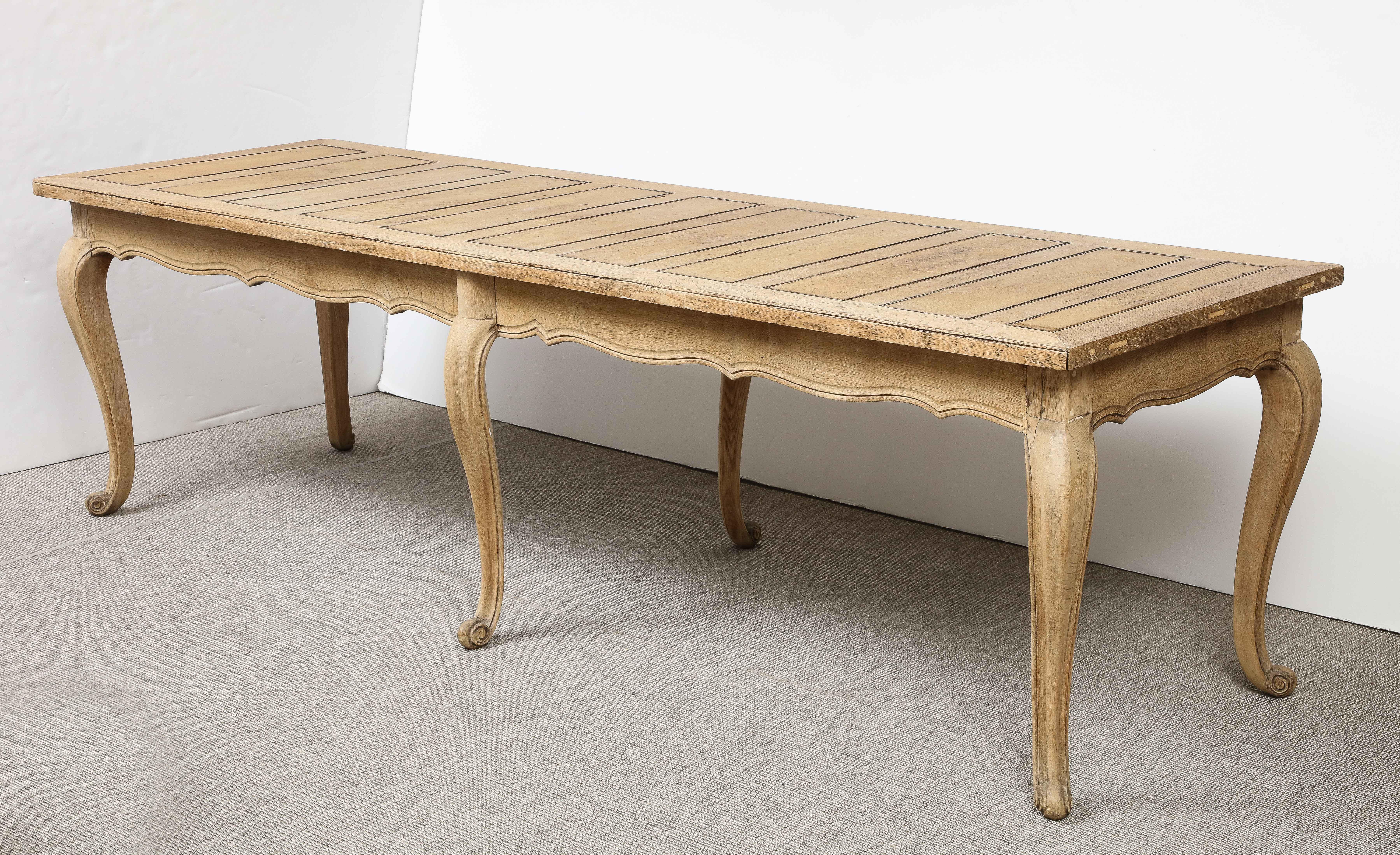 The bleached finish of this chic table gives it a fresh, modern appeal and allows it to work seamlessly in both a contemporary and a traditional setting.  The top consists of several decorative inset panels running the length of the table. True to