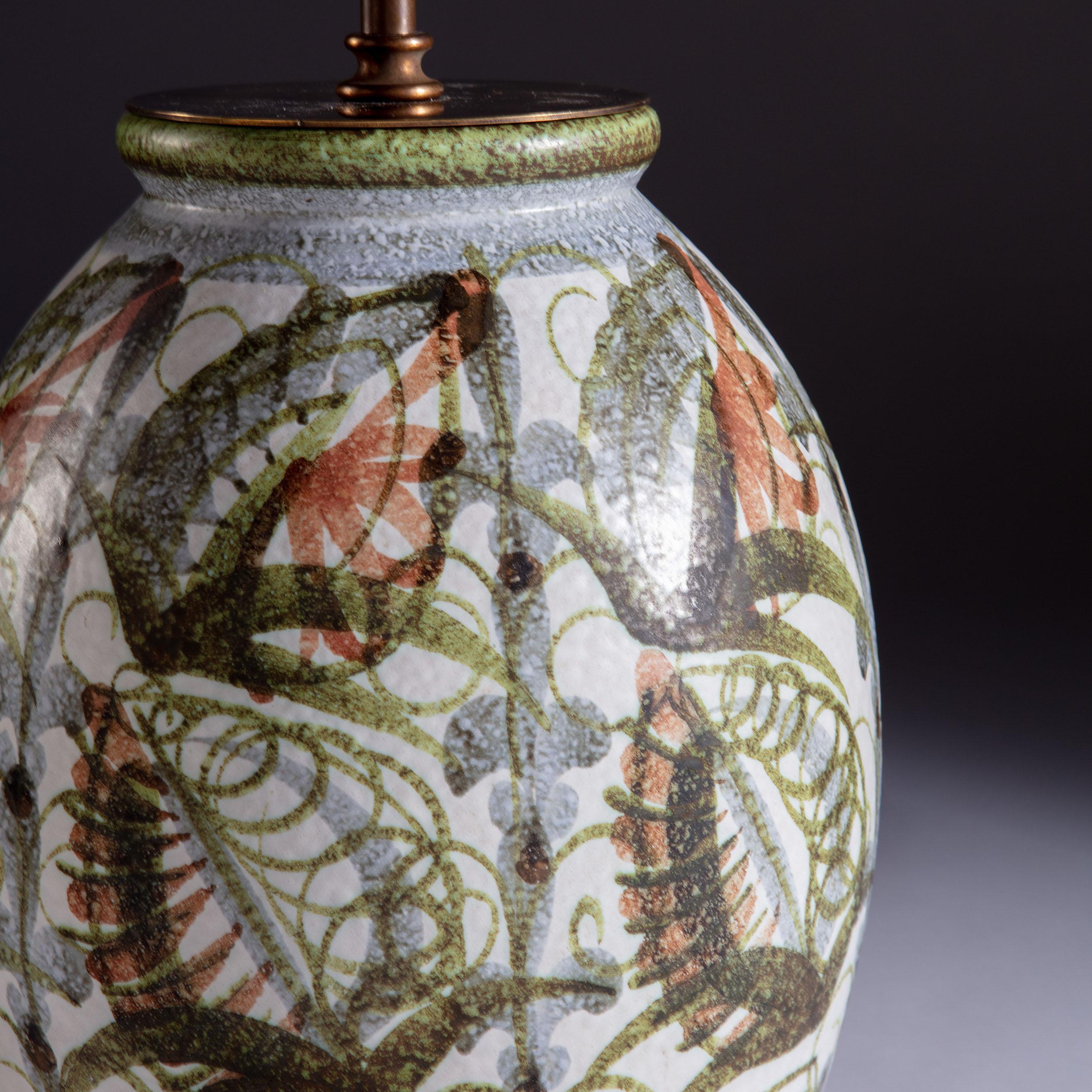 A mid twentieth century art pottery vase in the Bloomsbury Group style, decorated with foliate patterns throughout in autumnal colours, now converted as a lamp.

Please note: lampshade not included.

Currently wired for the UK. Please enquire