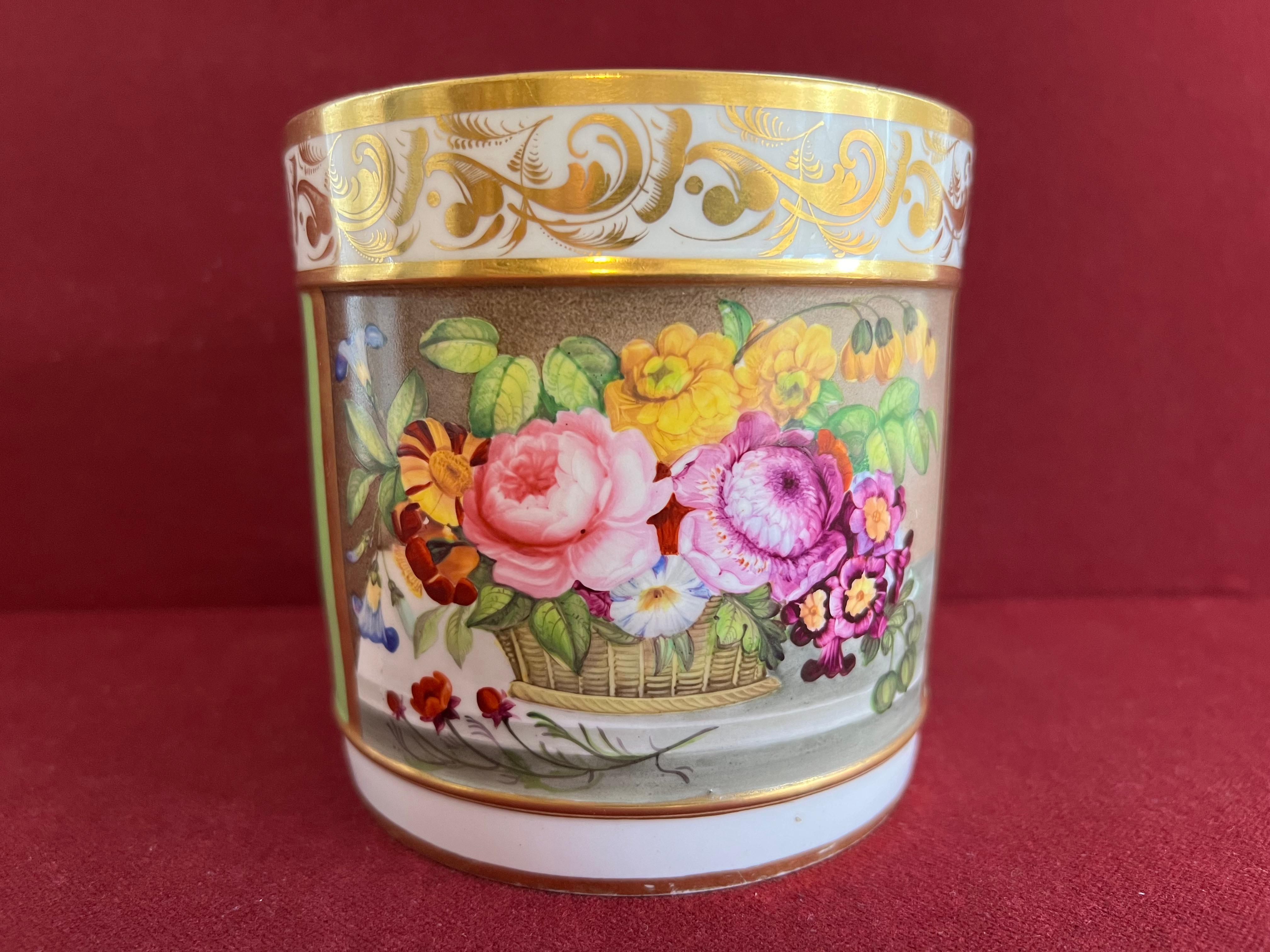 A fine Bloor Derby Porcelain porter mug c.1820-1825, finely decorated in the manner of Thomas Steel with a rectangular panel of flowers in a basket on a stone ledge, with a lime green ground beneath a gilt leaf scroll. Printed roundel mark in