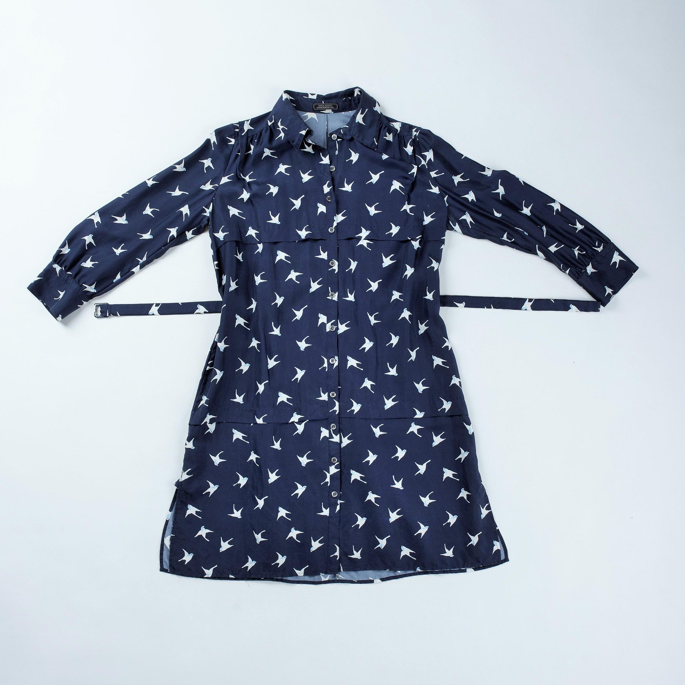 Circa 2000

France

Elegant and discreet blouse dress in navy silk twill printed with swallows by Nina Ricci.  Fluid dress with a belt at the waist and long three-quarter length sleeves with a little puff. Closed in the front by twelve pearly