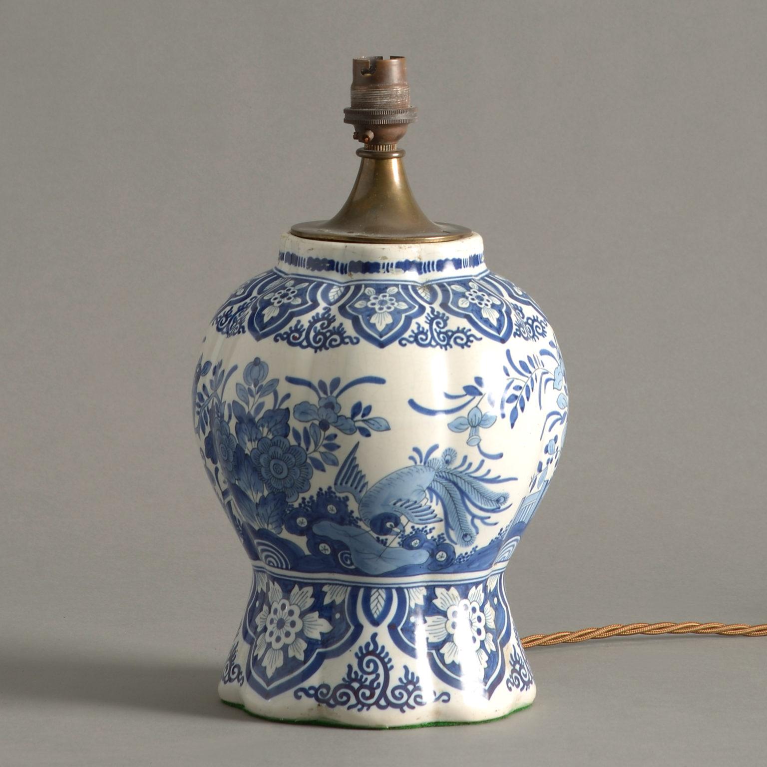A 19th century delft pottery baluster vase, decorated throughout with chinoiserie and now electrified as a table lamp.