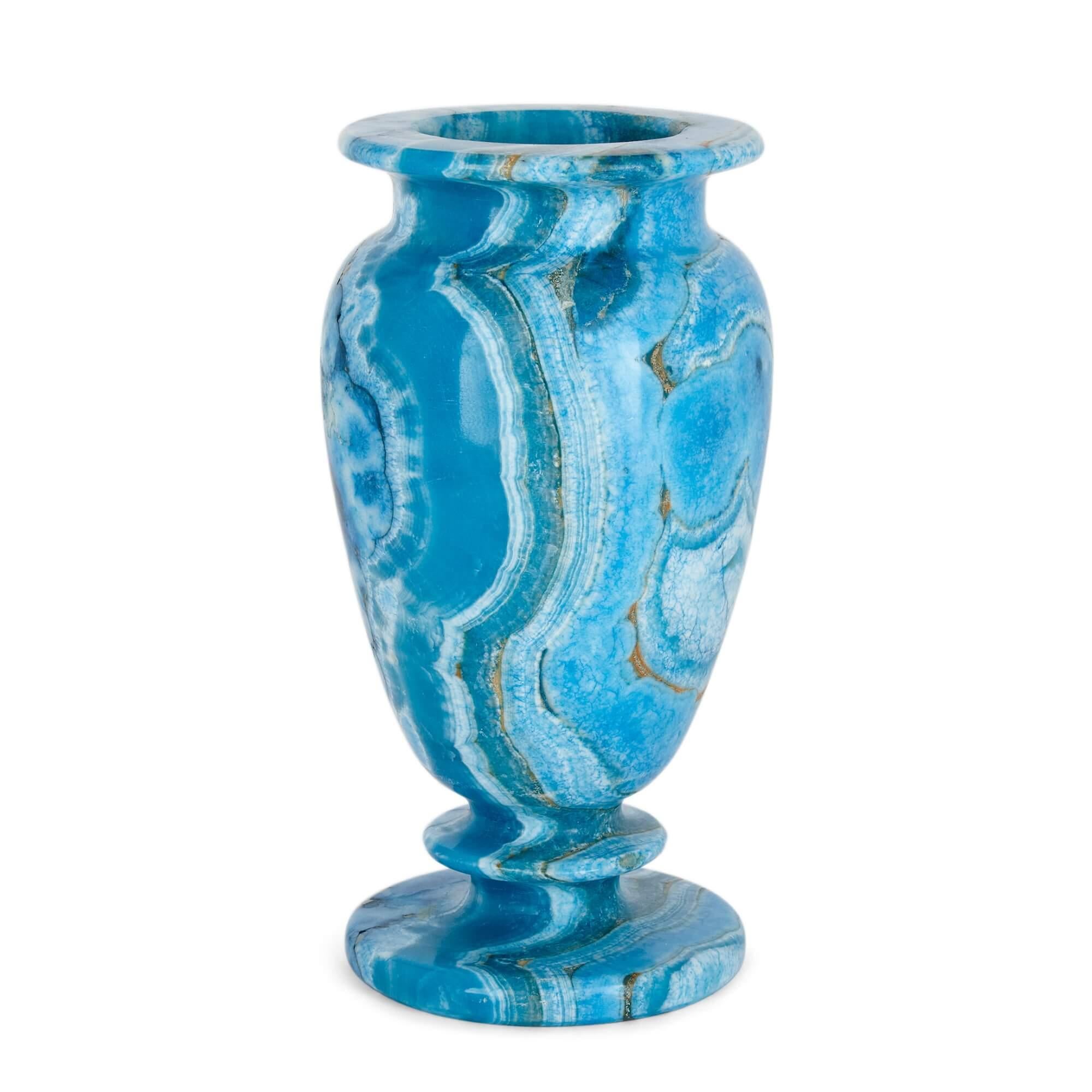 A blue-dyed calcite urn-shaped mineral vase.
Continental, 20th century.
Measures: height 25cm, width 13cm, depth 12cm.

This beautiful vase is a twentieth century Continental piece, of unclear provenance, made with naturally spectacular