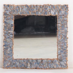 A Blue Kianyte and gilt resin wall mirror.