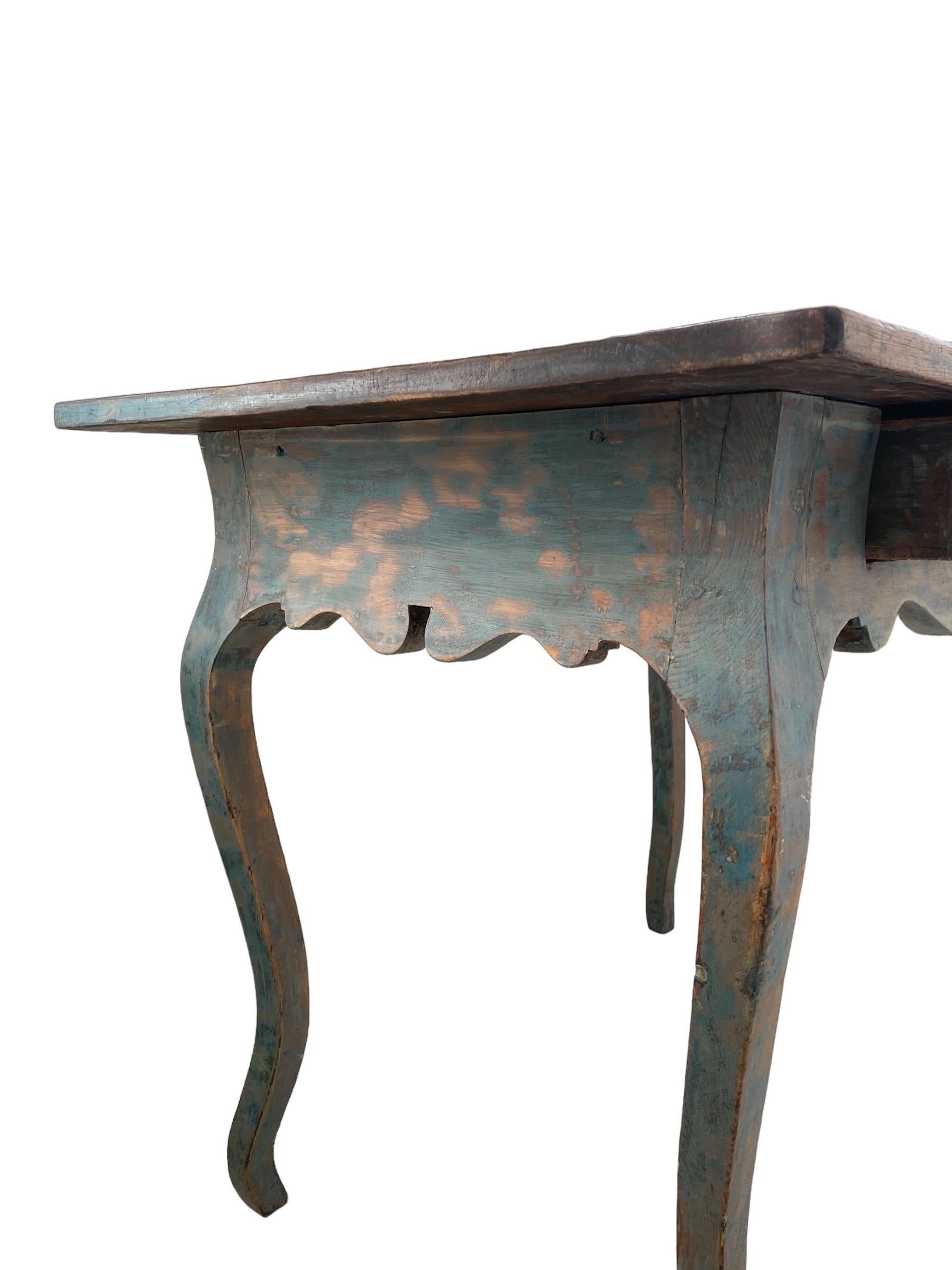 A beautiful 18th Rococo writing table in absolutely original condition. The table features a single drawer and a beautiful vintage patina with the original blue colour. The condition is consistent with age and use considering that the table is more