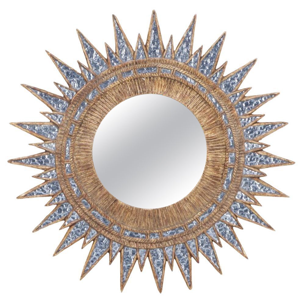 A blue textured glass and resin star form mirror in the manner of Line Vautrin.