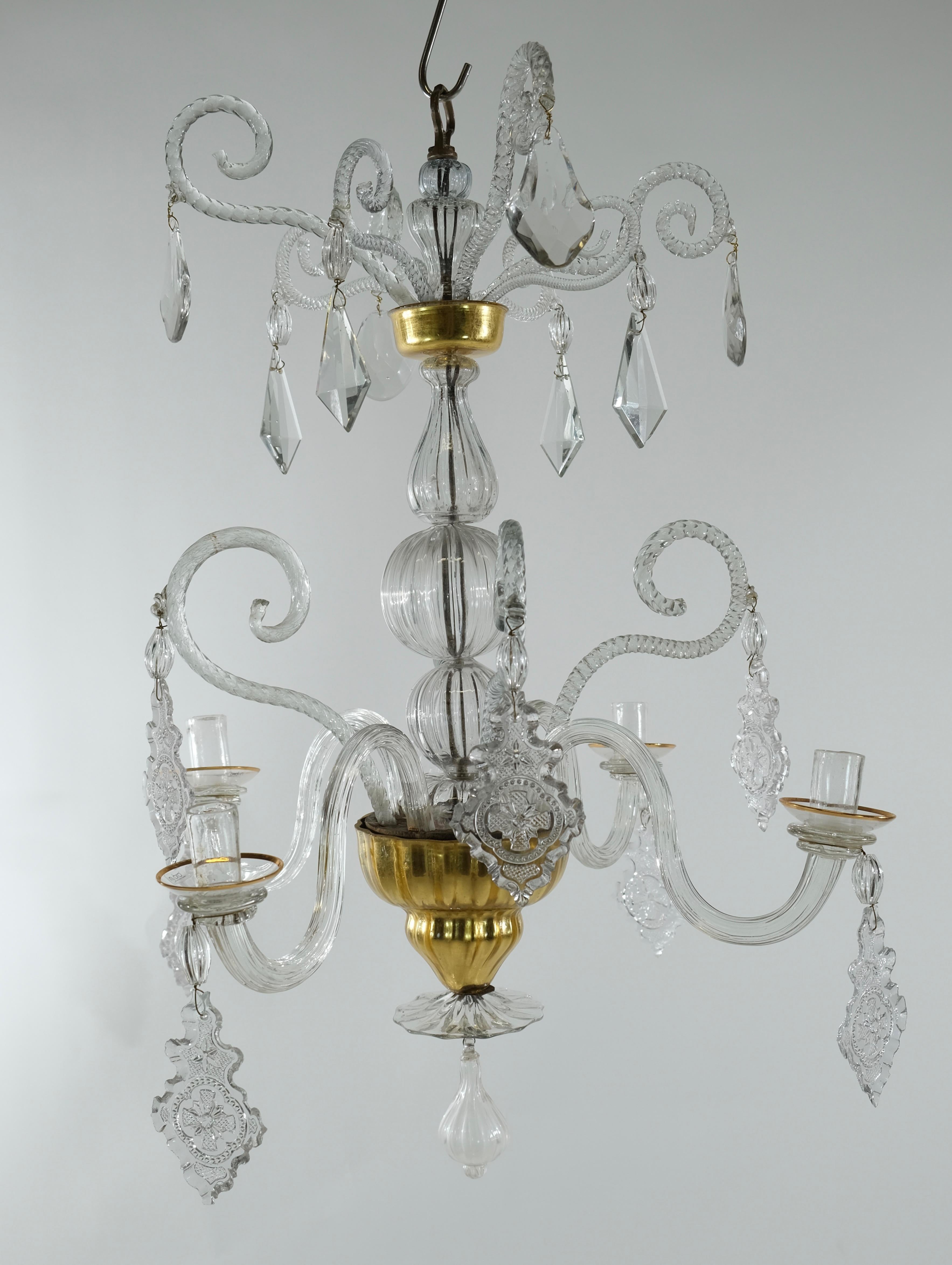 A charming Bohemian small four-armed chandelier. A forged iron rod holds all of the chandeliers different glass parts. Central are handblown 