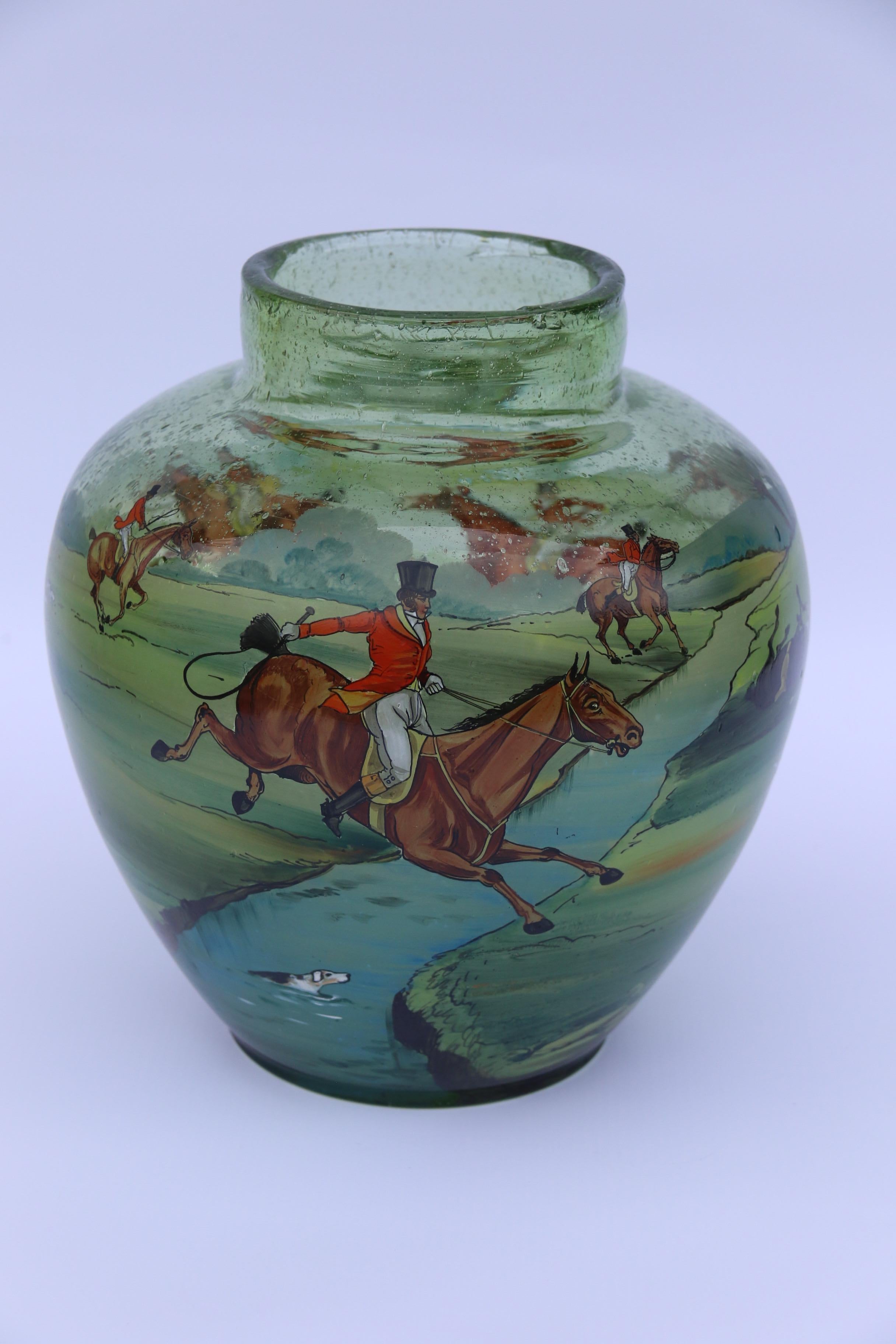 An outstanding large Bohemian hand blown green glass vase decorated with a superb hand painted enamelled fox hunting scene.

This rare and decorative large glass vase was produced in Bohemia circa 1920. It is hand blown in apple green thick glass