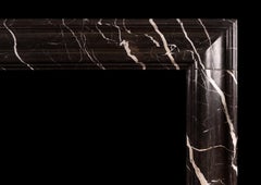 A Bolection Fireplace in Bruno Marquina Marble