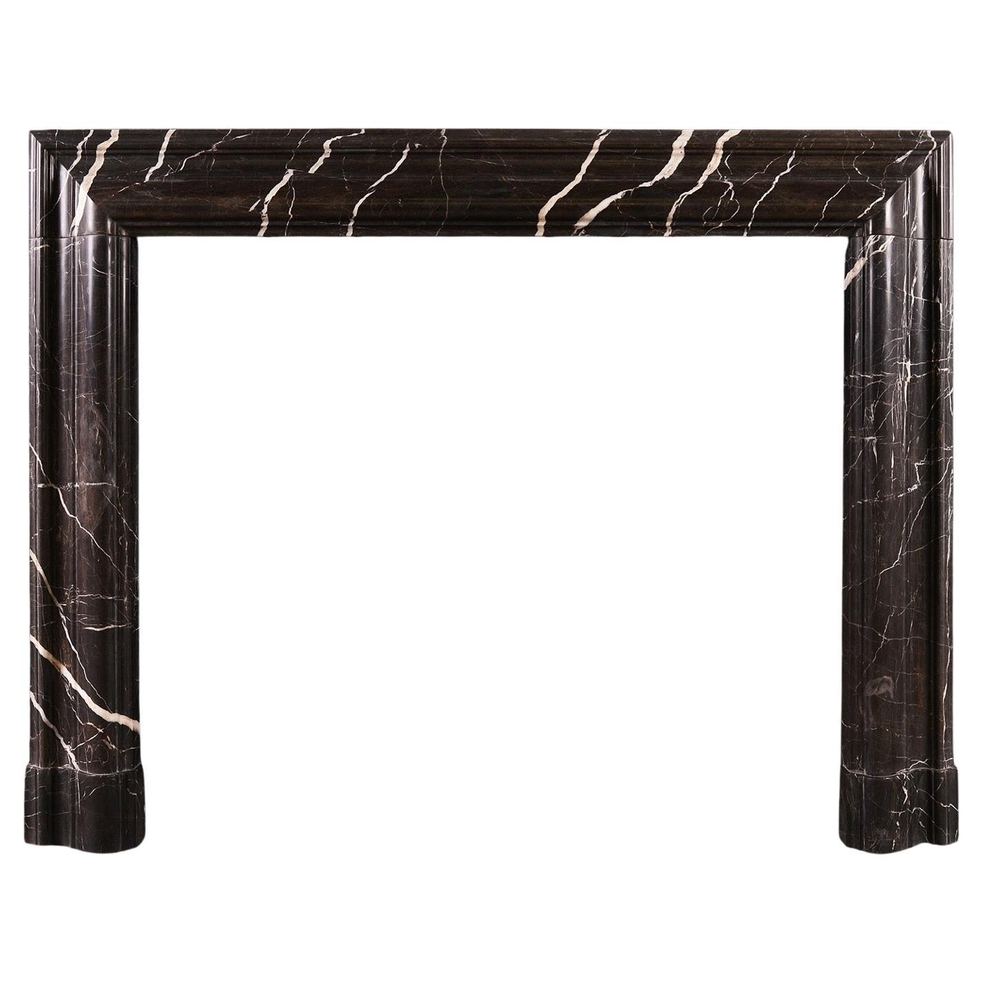 A Bolection Fireplace in Bruno Marquina Marble For Sale