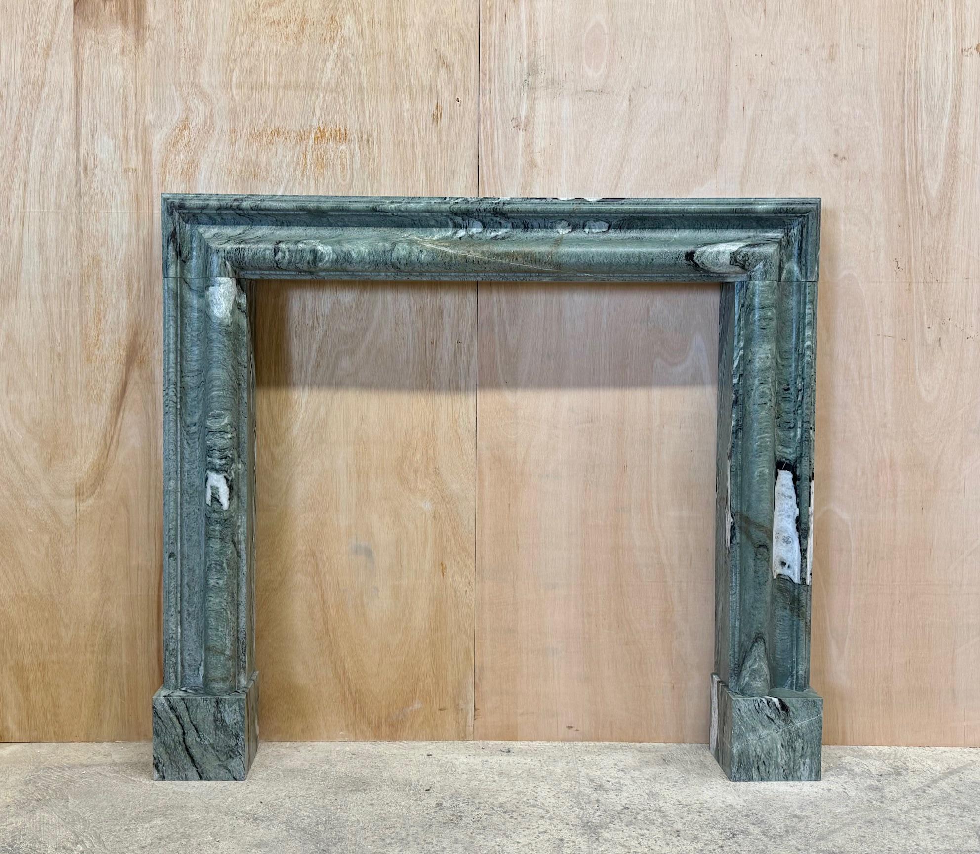 A small to medium sized bolection style fire surround made from an old block of Irish Connemara marble, quarried over 100 years ago. 
The block was only large enough to make two fireplaces, making each of these quite rare mantels. 
A classic