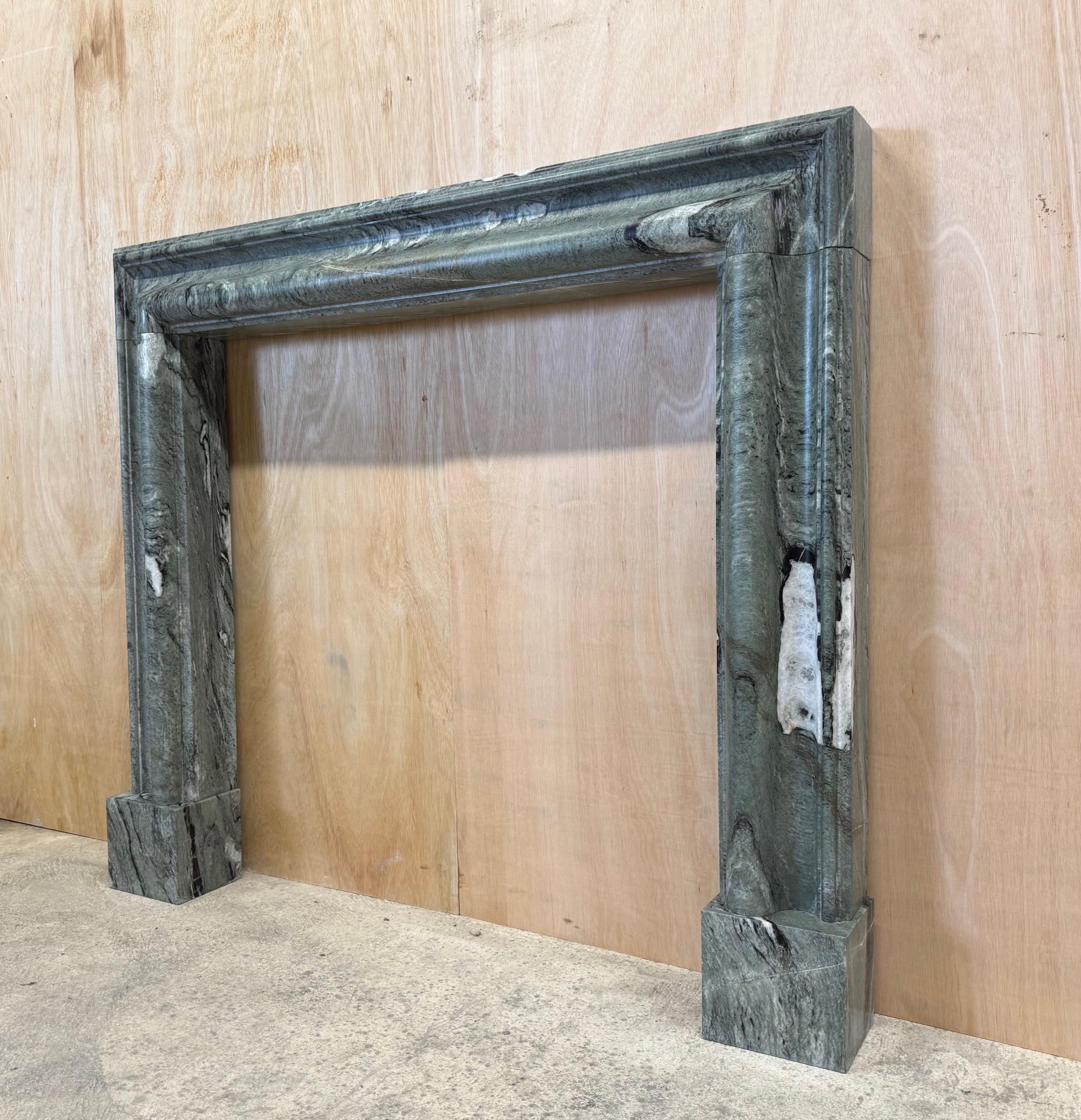 Modern A bolection style Connemara Marble Mantel, Fireplace by Ryan & Smith For Sale
