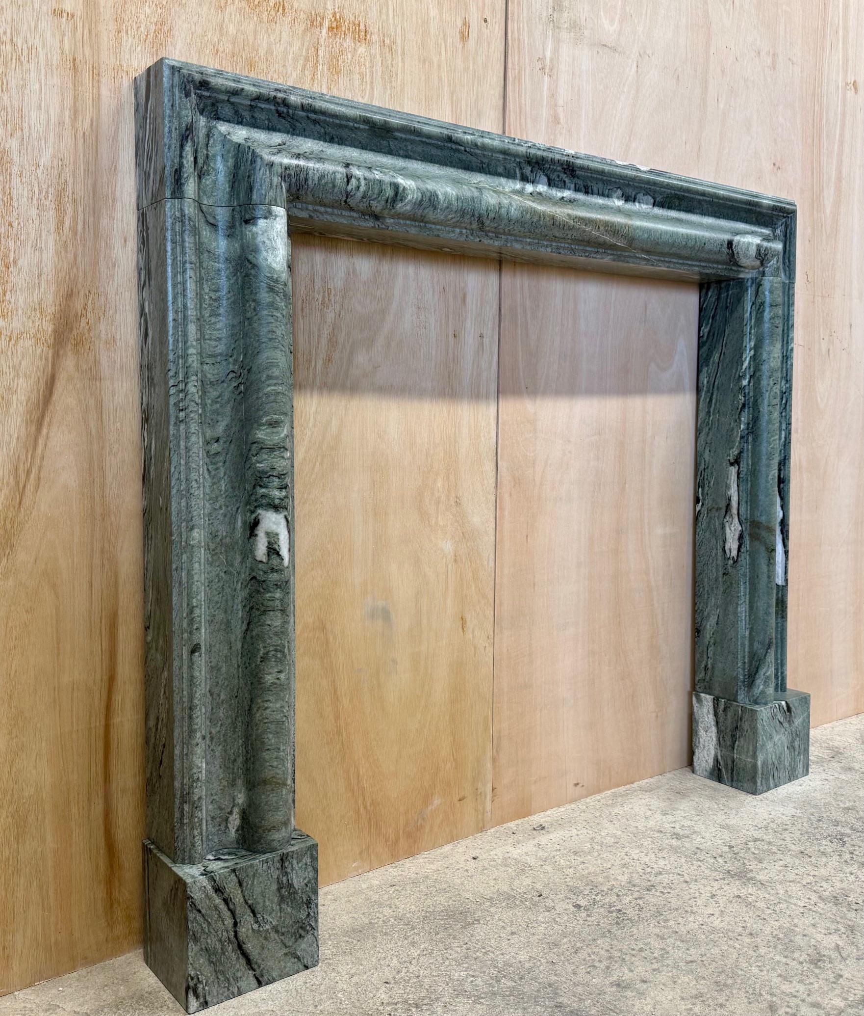 Northern Irish A bolection style Connemara Marble Mantel, Fireplace by Ryan & Smith For Sale