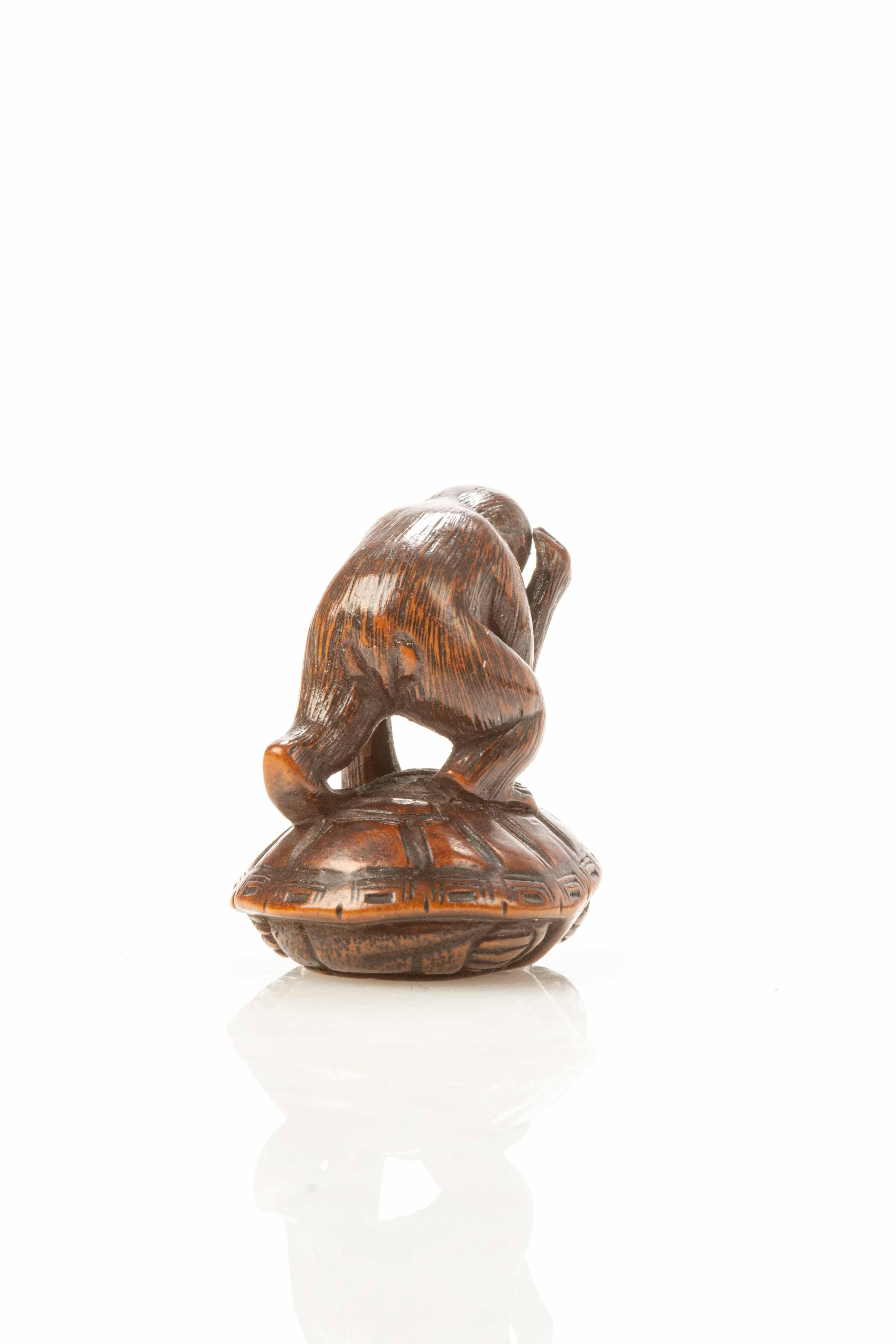 Japanese A boxwood netsuke depicting a monkey trying to catch a turtle For Sale