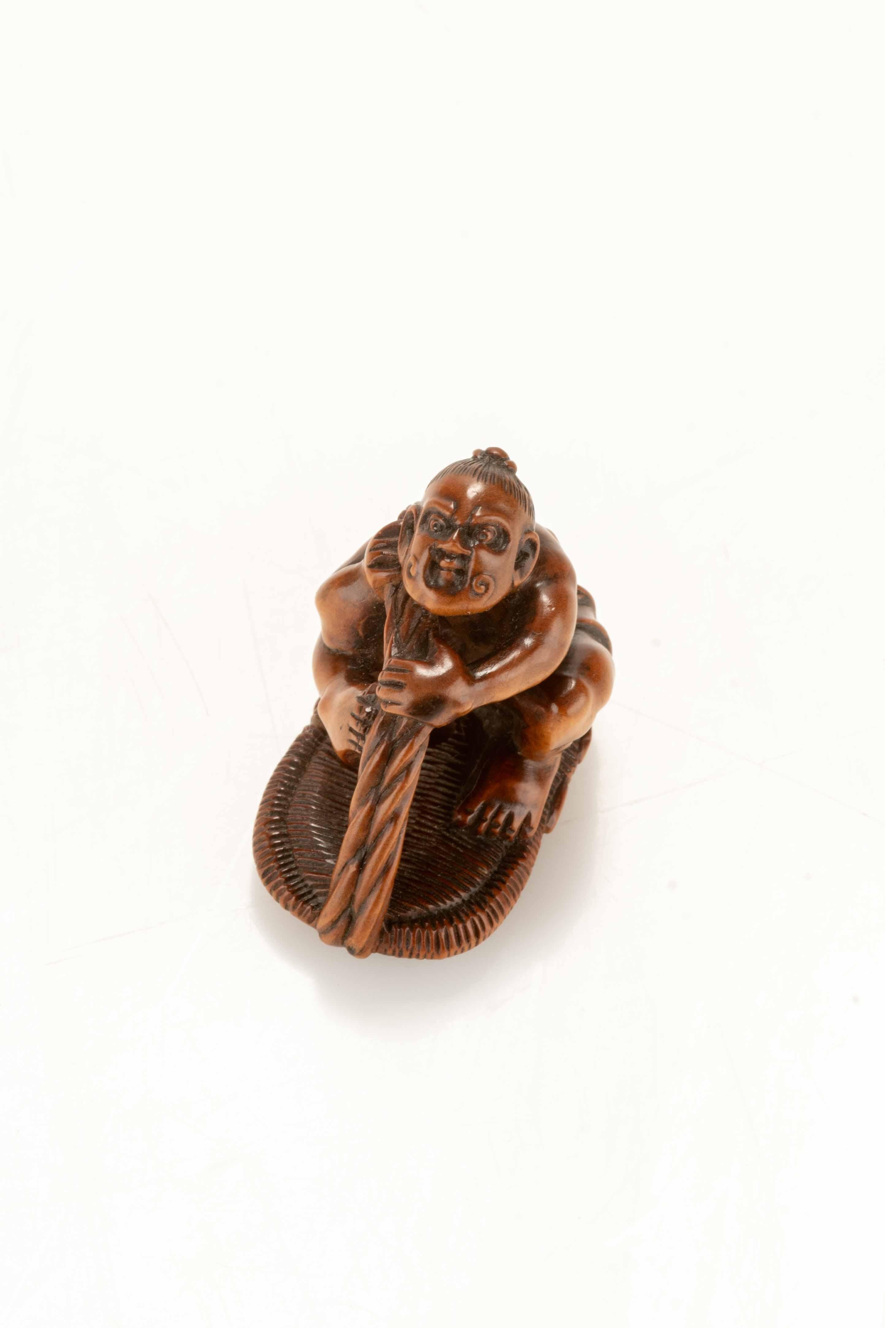 Carved A Boxwood Netsuke Depicting A Nio With A Giant Sandal