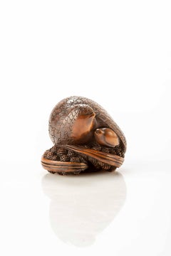 A Boxwood Netsuke Depicting A Pair Of Quails Crouching On Millet