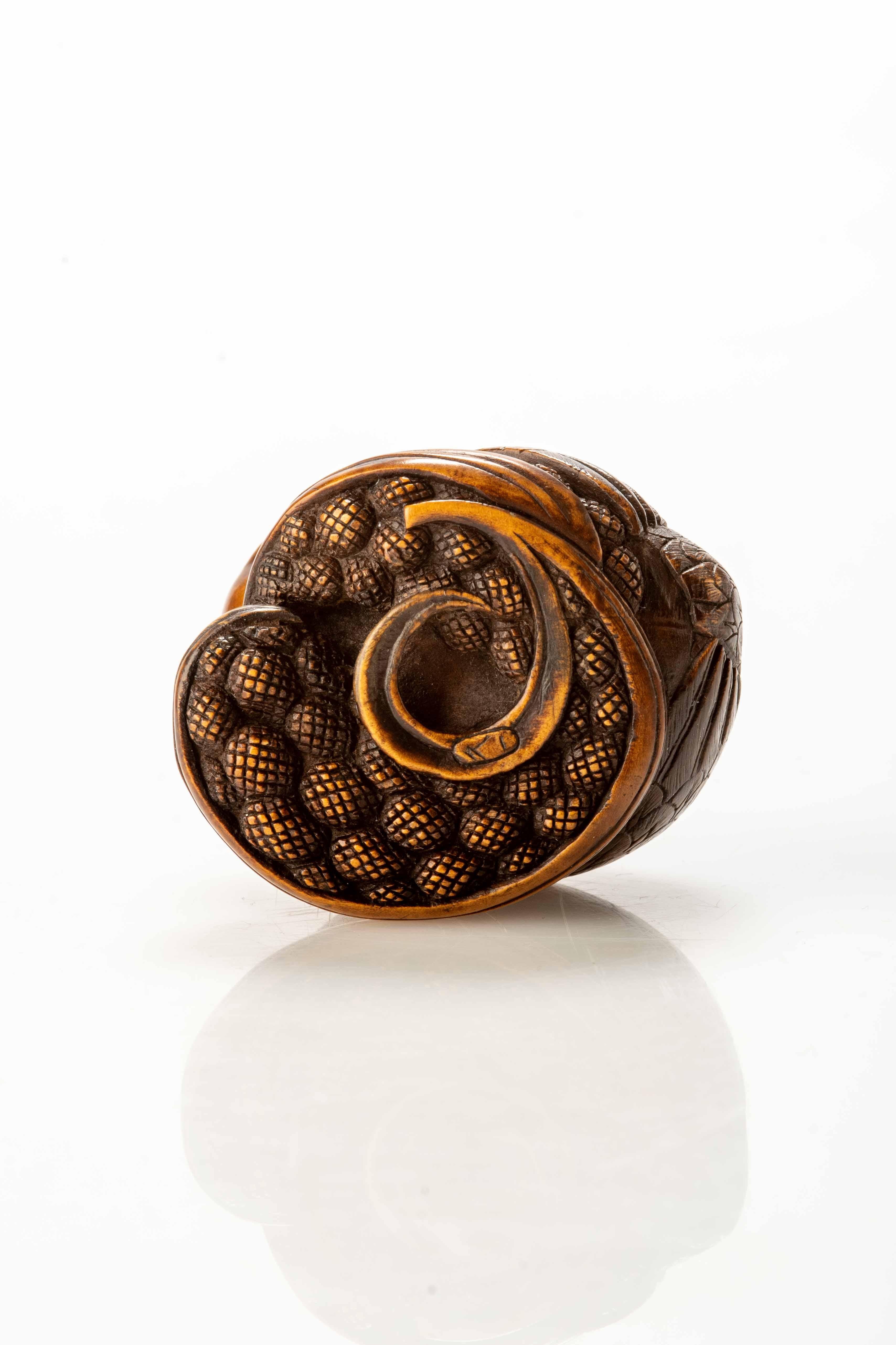 Carved A Boxwood Netsuke Depicting A Pair Of Quails Crouching On Millet