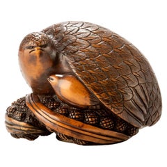 A Boxwood Netsuke Depicting A Pair Of Quails Crouching On Millet