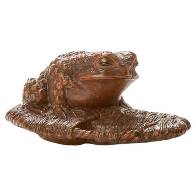 A Boxwood Netsuke Depicting A Toad Resting On A Sandal For Sale
