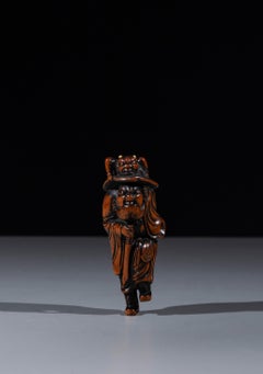 A boxwood netsuke depicting Shōki with an Oni