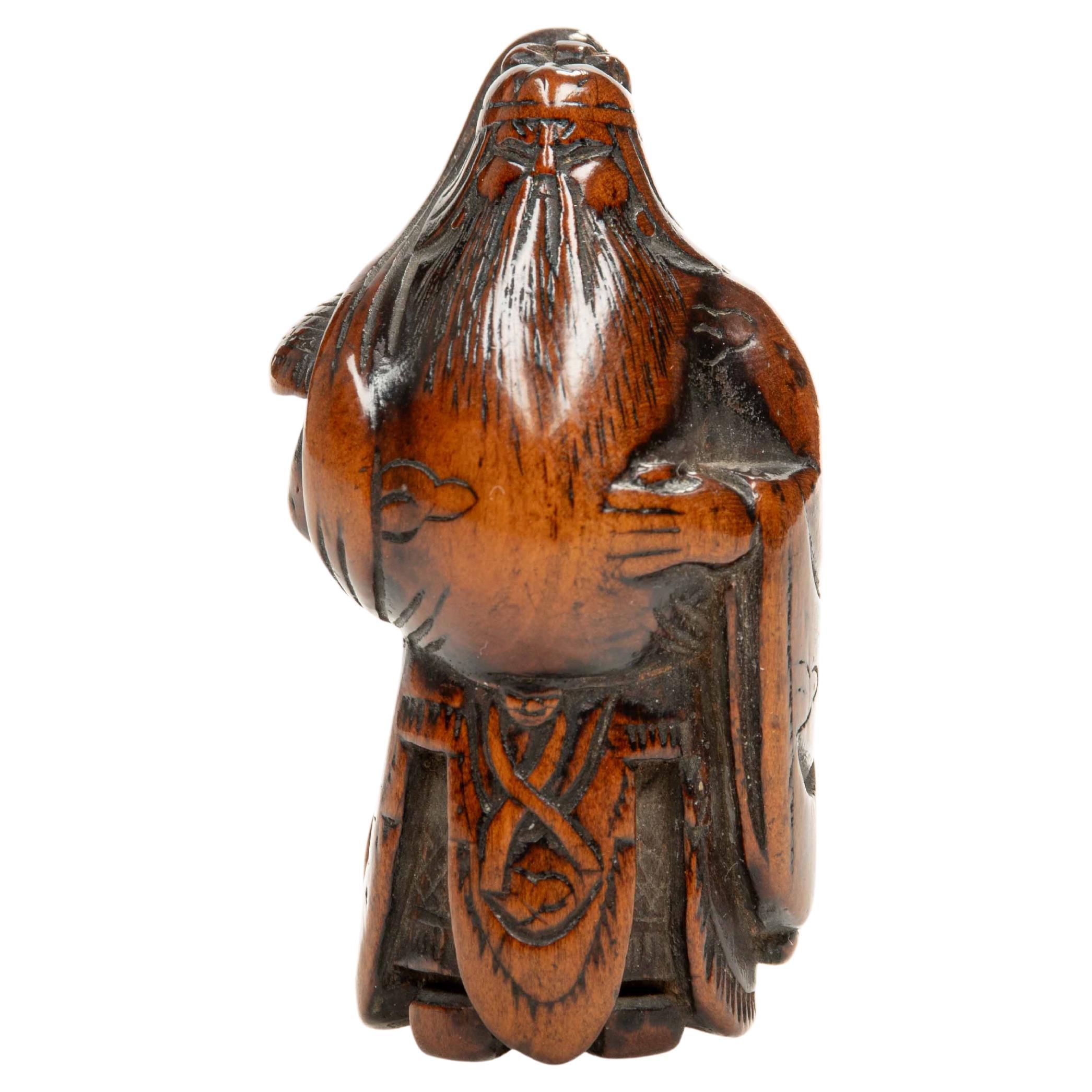 A boxwood netsuke depicting the Chinese general Guan Yu