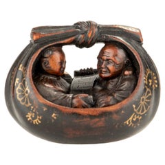 A boxwood netsuke of Hotei and a karako in the sack