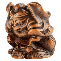 Netsuke en buis de Shoki avec un Oni