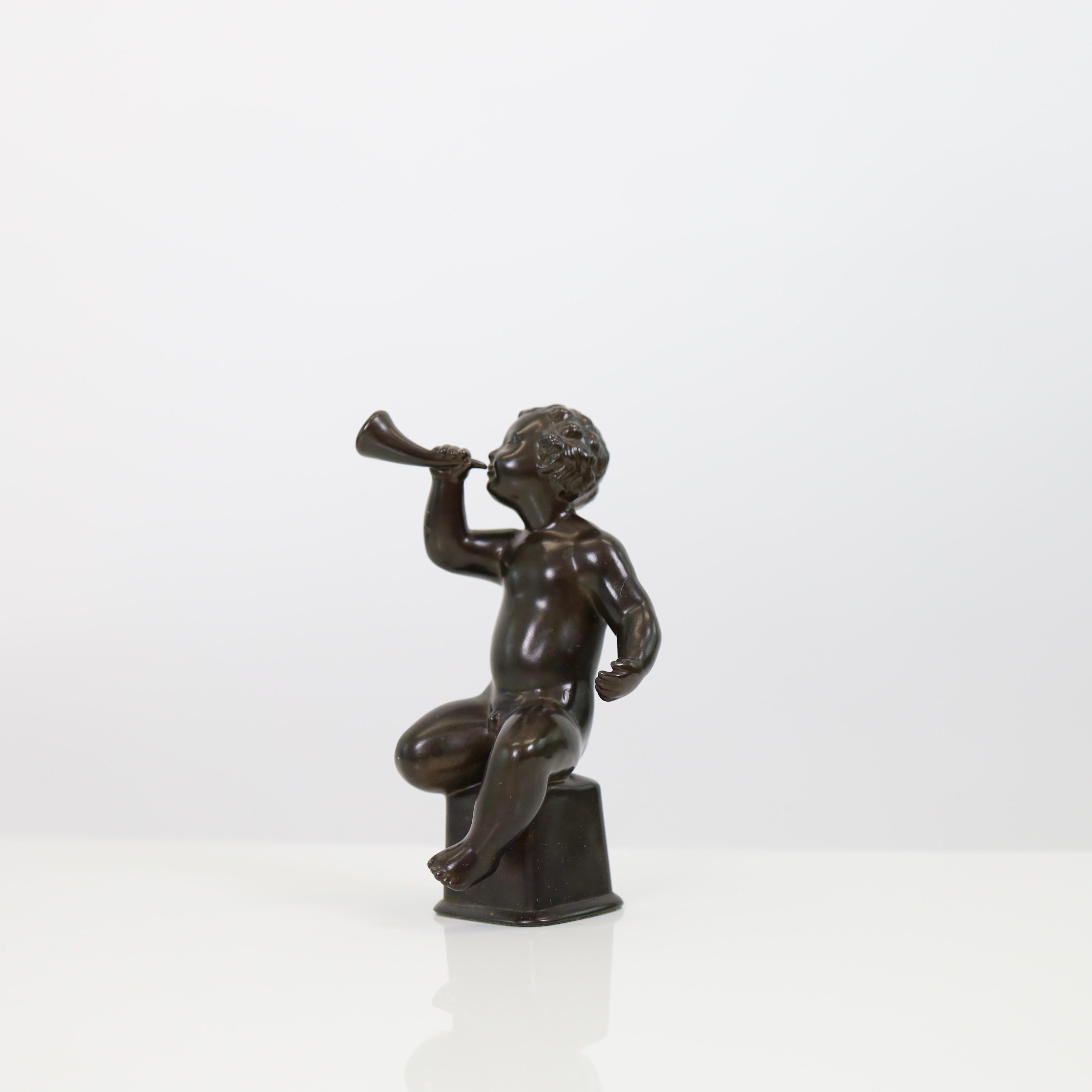 A little, exquisite 'Boy with horn' bust in excellent condition designed by Just Andersen in 1939.

* A small metal sculpture of a boy with a horn
* Designer: Just Andersen
* Model: D2170 (stamped 'Just D2170’)
* Condition: Excellent vintage