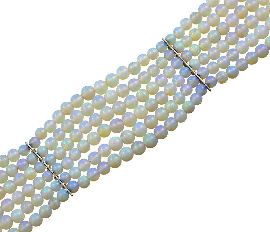6 rows of lovely Opal Beads with 2 Diamond set spacers and a Diamond set Clasp, the Bracelet with a  length of 7 inches and a width of 1 inch all of which looks best on a darker skin tone.
I have had one other such Bracelet in a 30 year period so