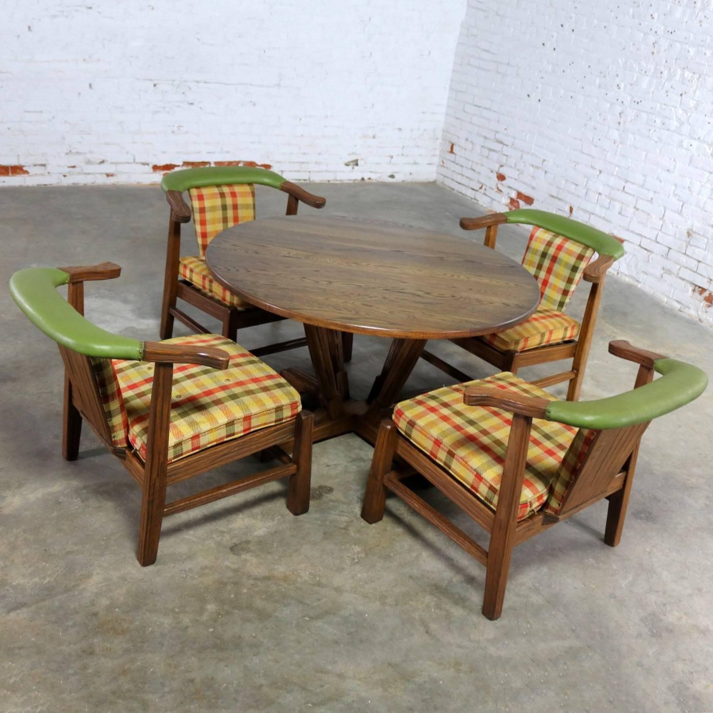 Handsome and unique game table and four chairs by A. Brandt Company from their Ranch Oak collection called the Brunch Table model #2906. This table and chair set is in wonderful vintage condition with their original wood finish and plaid upholstery.
