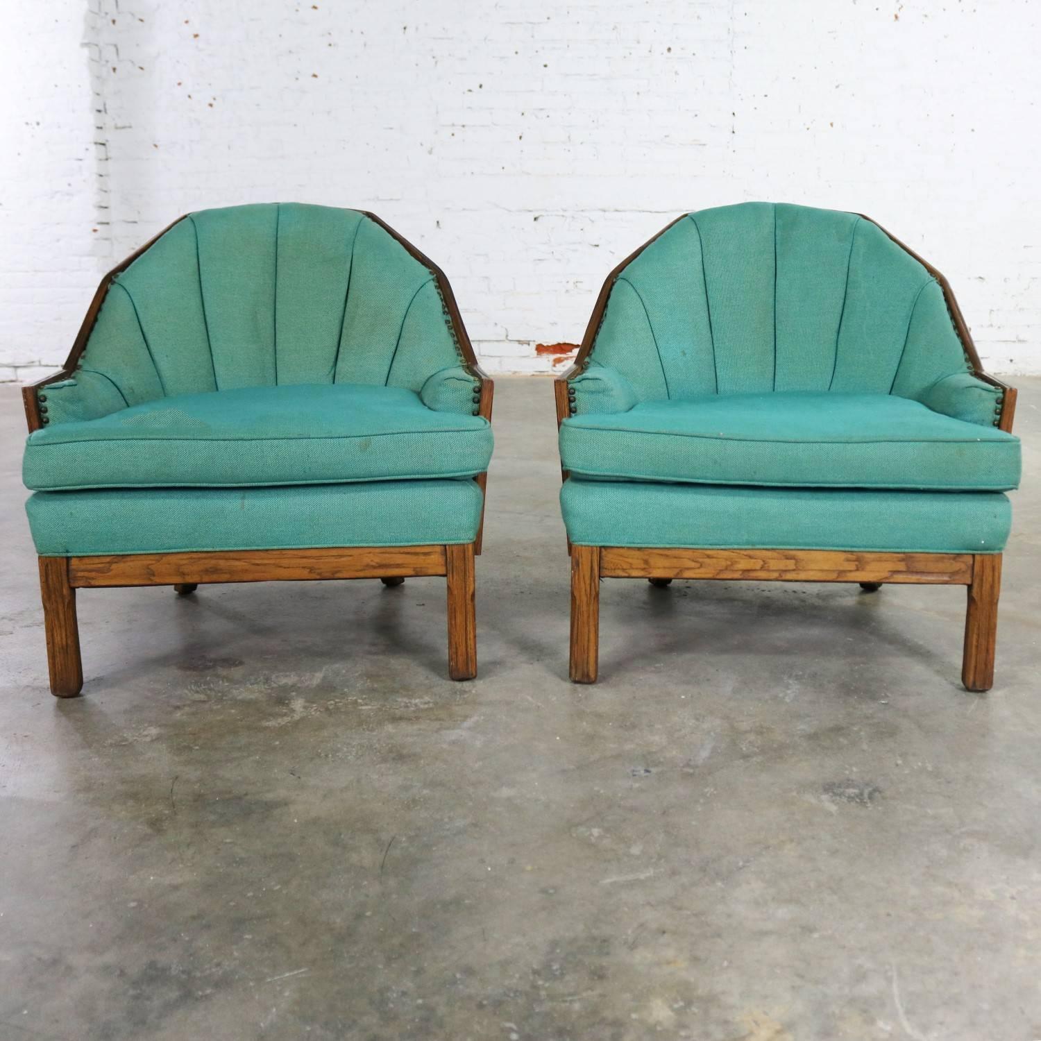 Fabulous pair of barrel shaped club chairs by A. Brandt Company from their Ranch Oak collection in their incredible cowboy western style with the planked and pegged oak. They are in wonderful solid condition and although the original turquoise