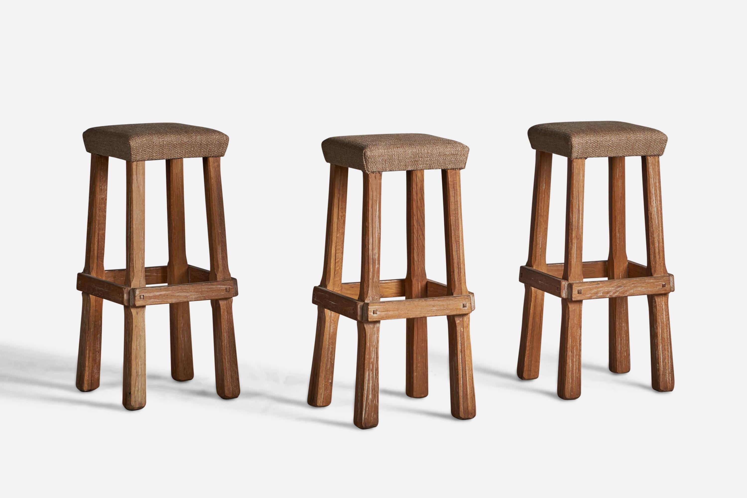 A set of 3 oak and beige fabric bar stools, designed and produced by A. Brandt Ranch Oak, USA, c. 1950s.