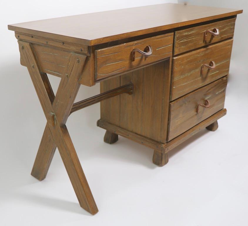 Great Ranch oak, Brandt cowboy modern desk, having a X form leg, a pencil drawer, and a bank of three deep drawers. The desk is of oak, in original Cerused finish, with a Formica top. We have two of these available, offered and priced